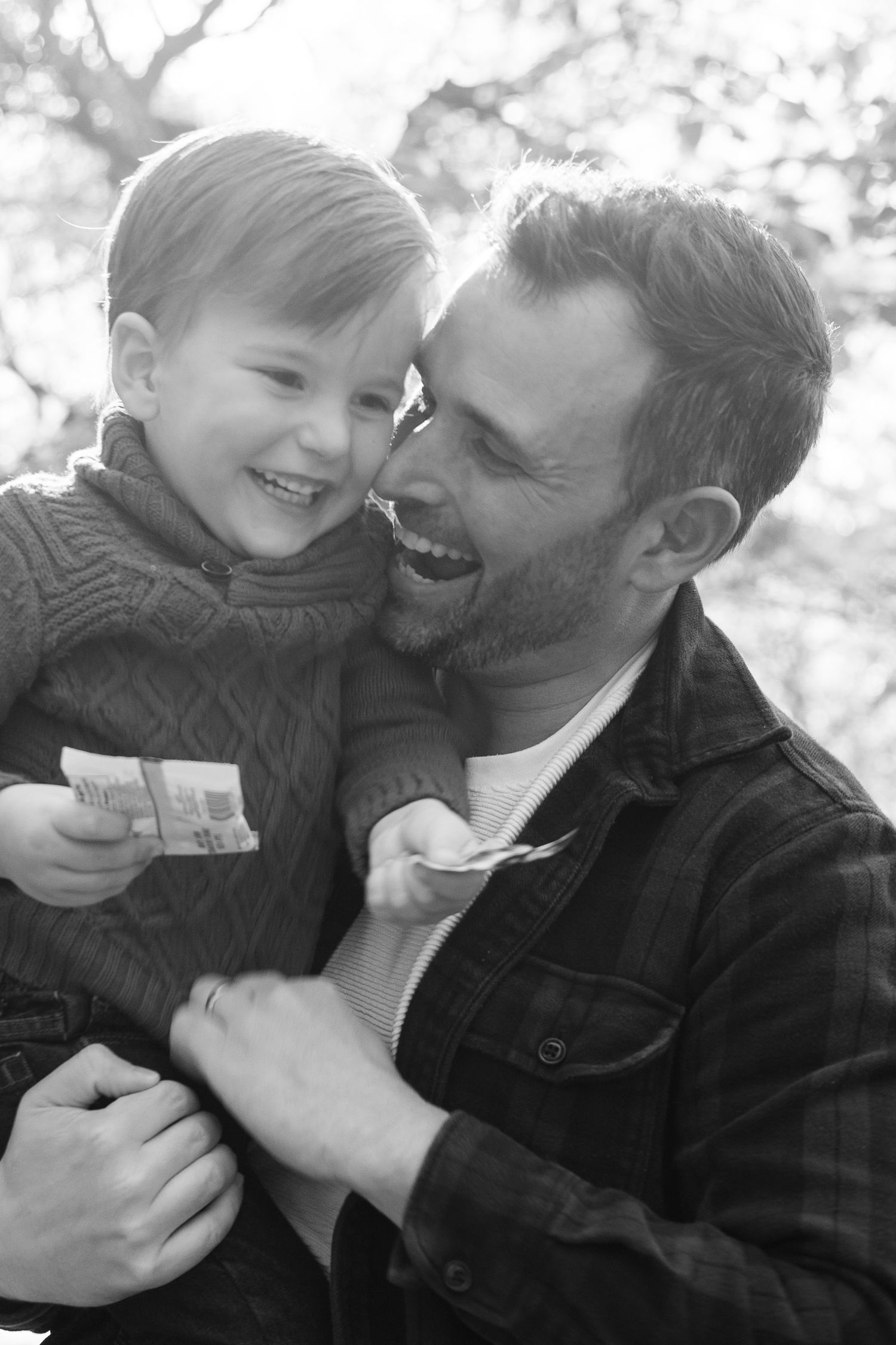 Black and white portrait showing intimate moment of joy and laughter.