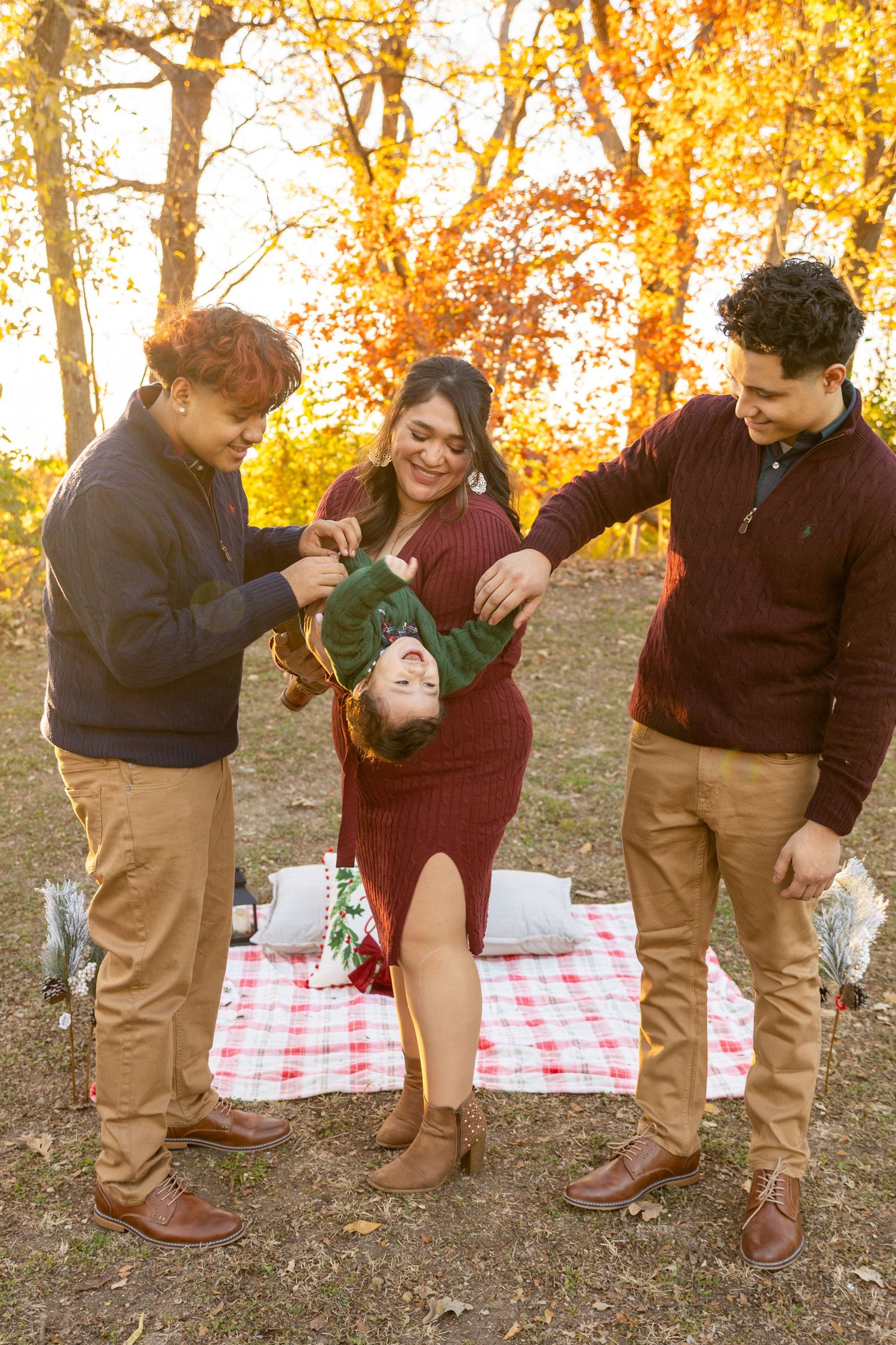 Fun sequence of people playing and posing on a red checkered picnic blanket in autumn.