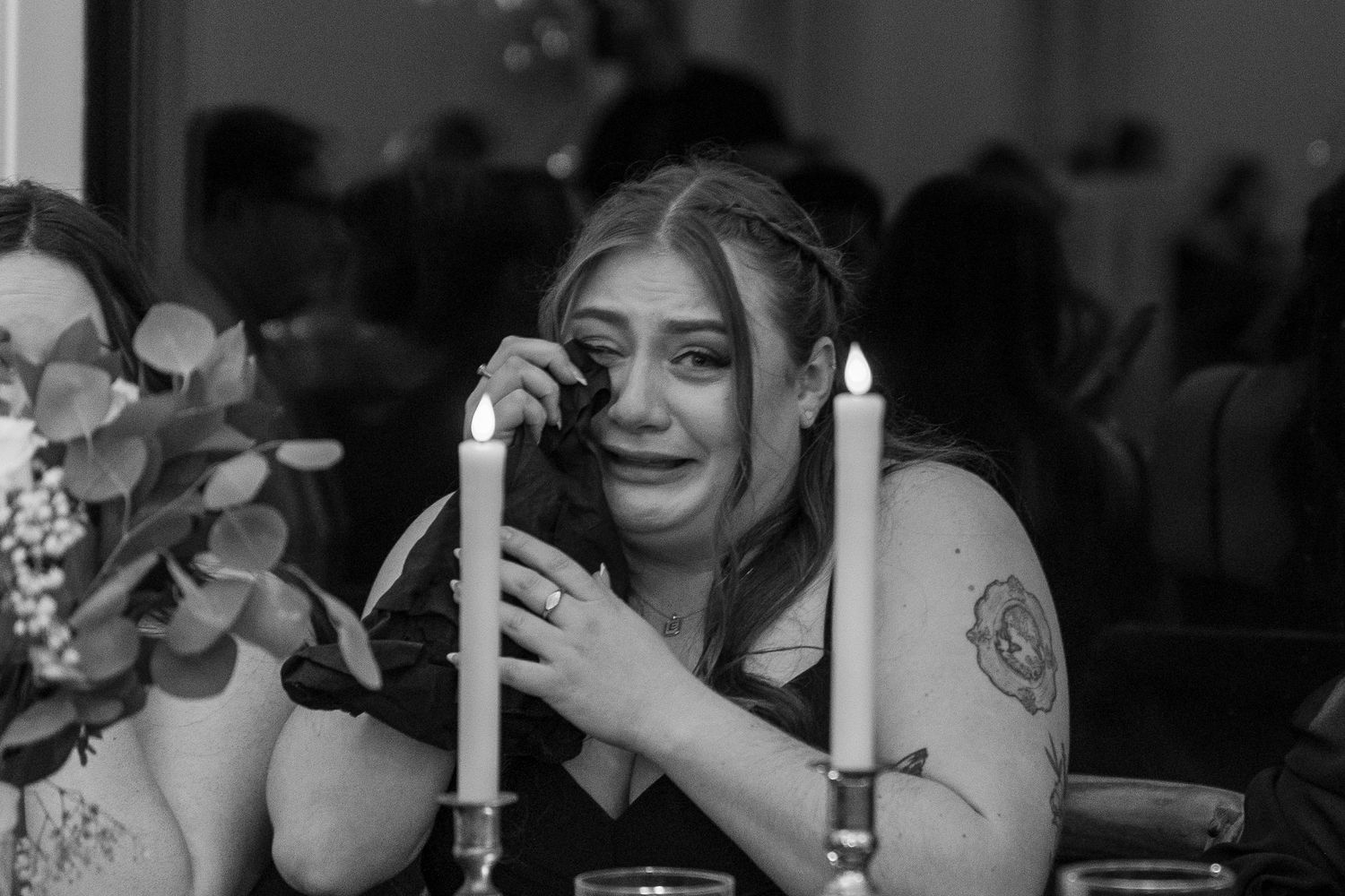 Emotional black and white wedding reception moments captured in candid shots.