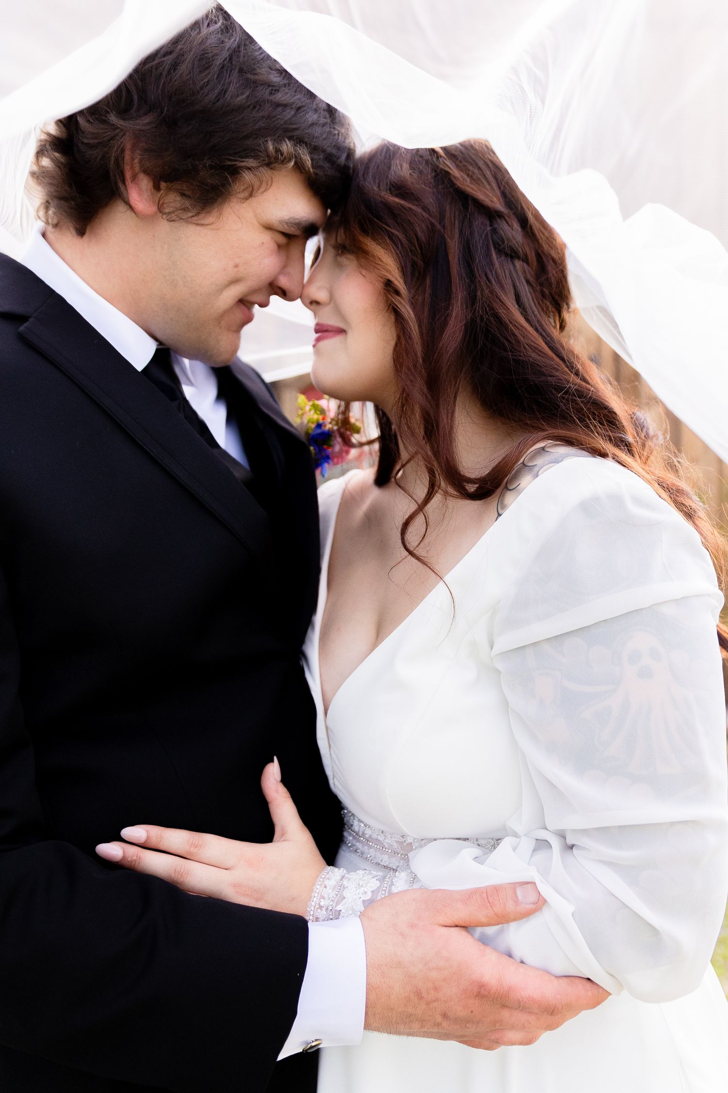 Intimate black and white portrait of newlyweds sharing a tender moment.