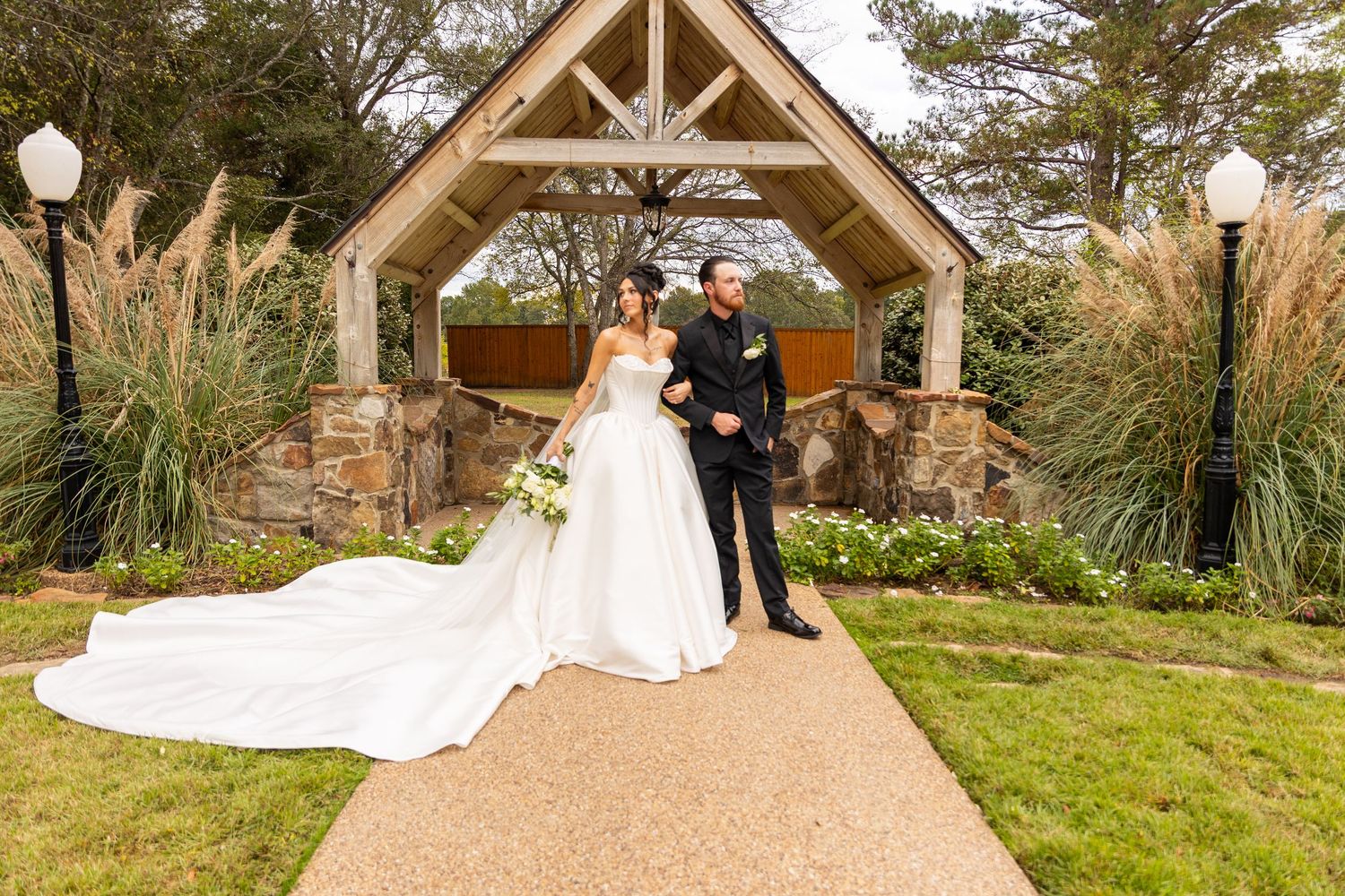 Wedding ceremony at rustic wooden pavilion surrounded by natural landscape.