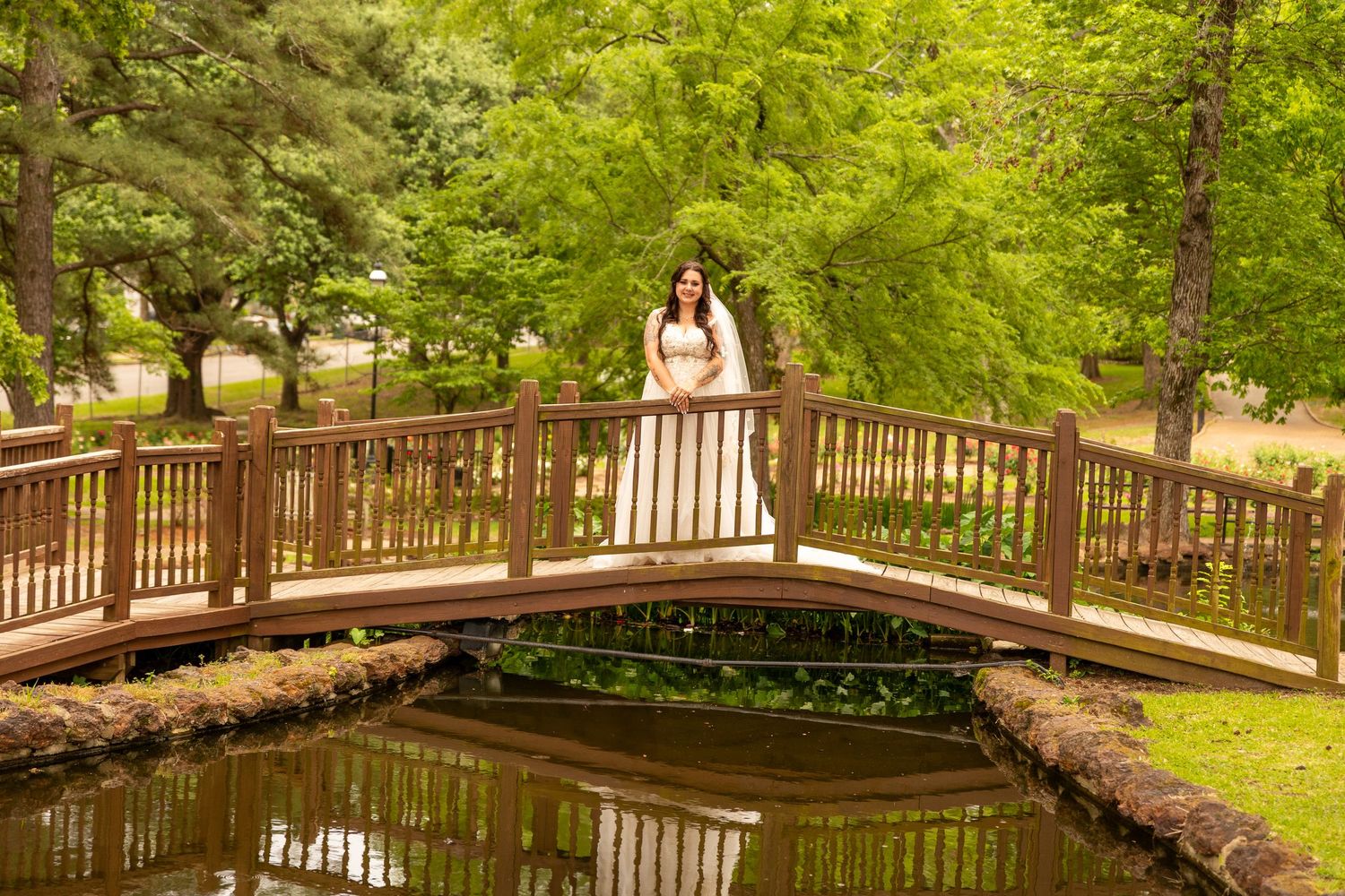 Wooden deck walkway surrounded by lush greenery creates a serene outdoor setting.