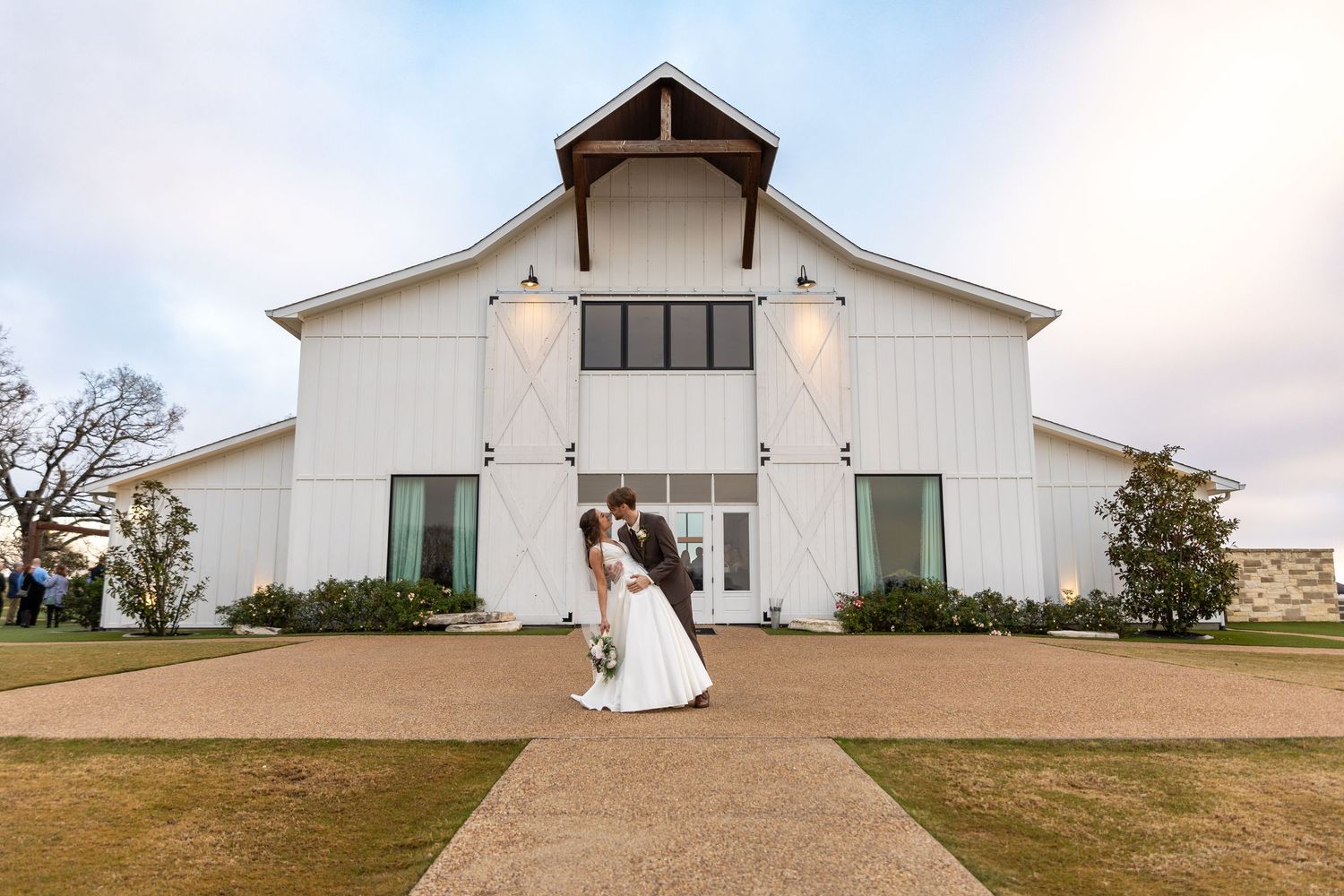 Exterior view of a modern white wedding chapel on a hilltop.