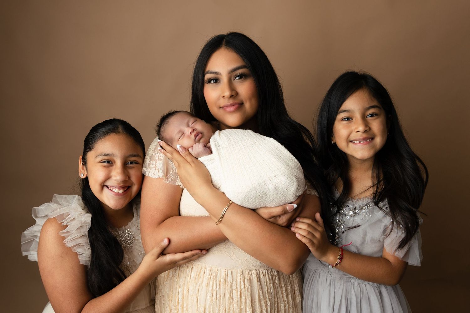 Studio portrait series showing family members in coordinated gray and white outfits.