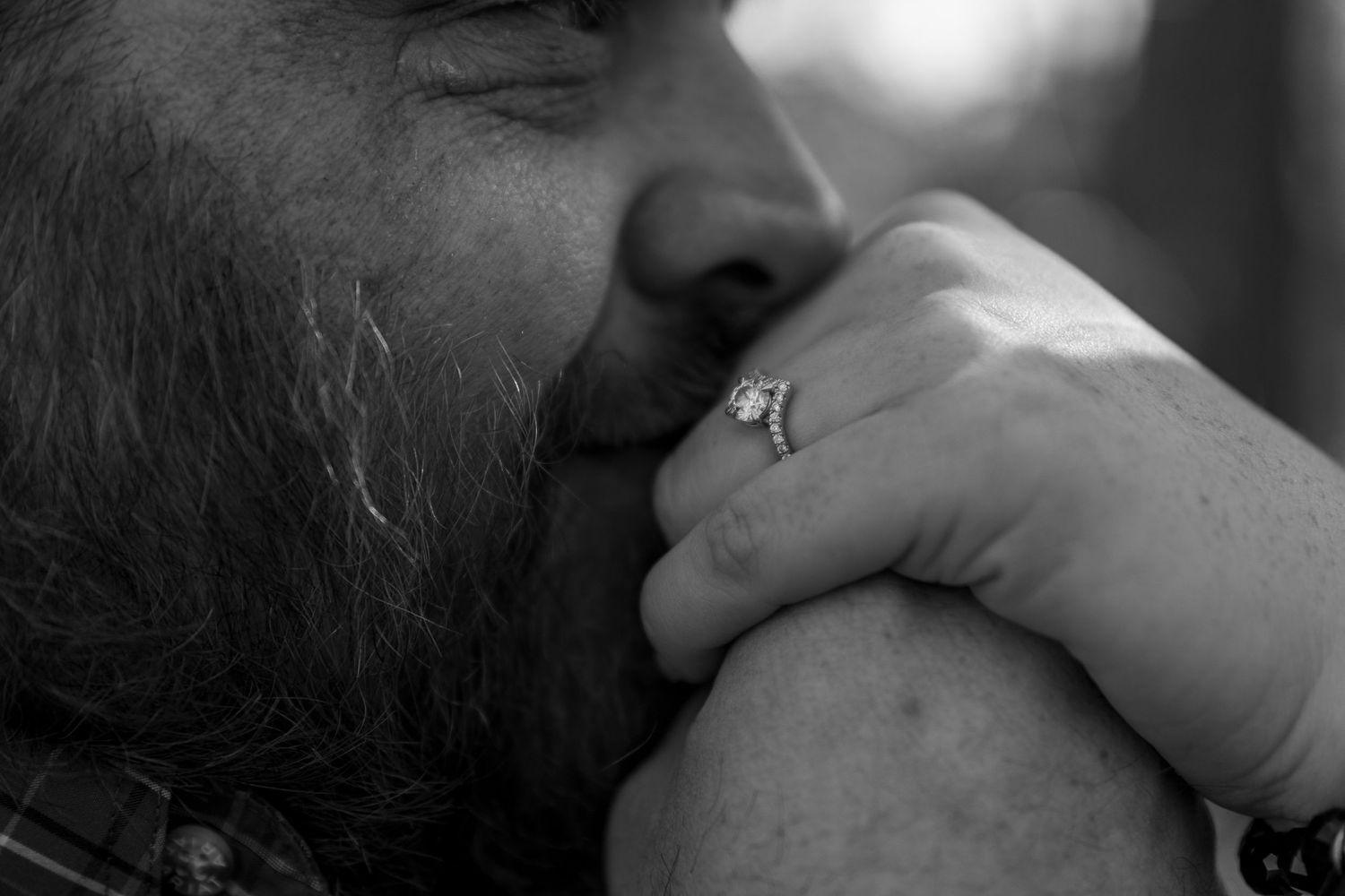 Close-up black and white romantic portrait showing tender intimacy between a couple.