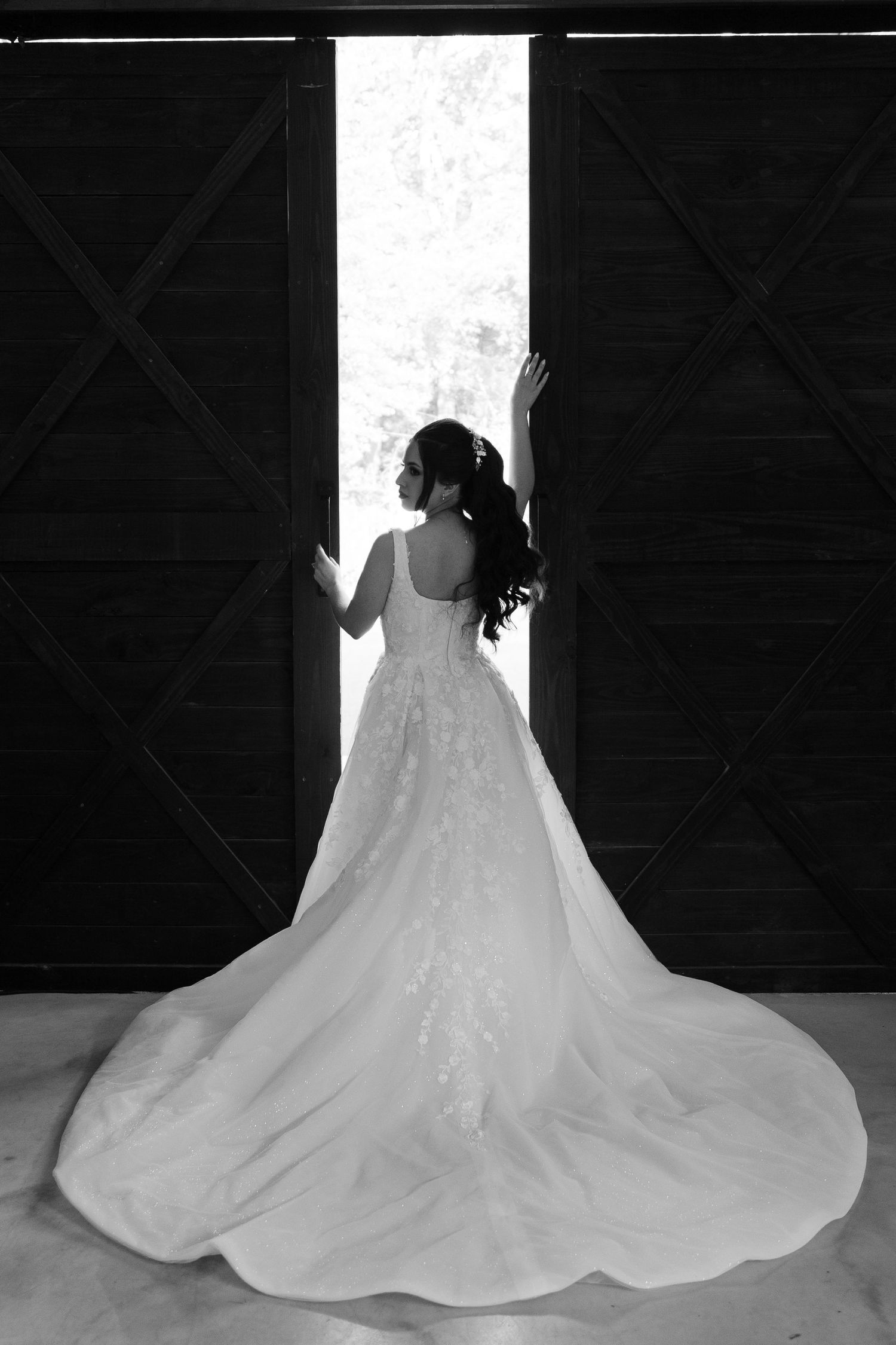 Dramatic silhouette shots of bride's wedding dress train in dark indoor setting.