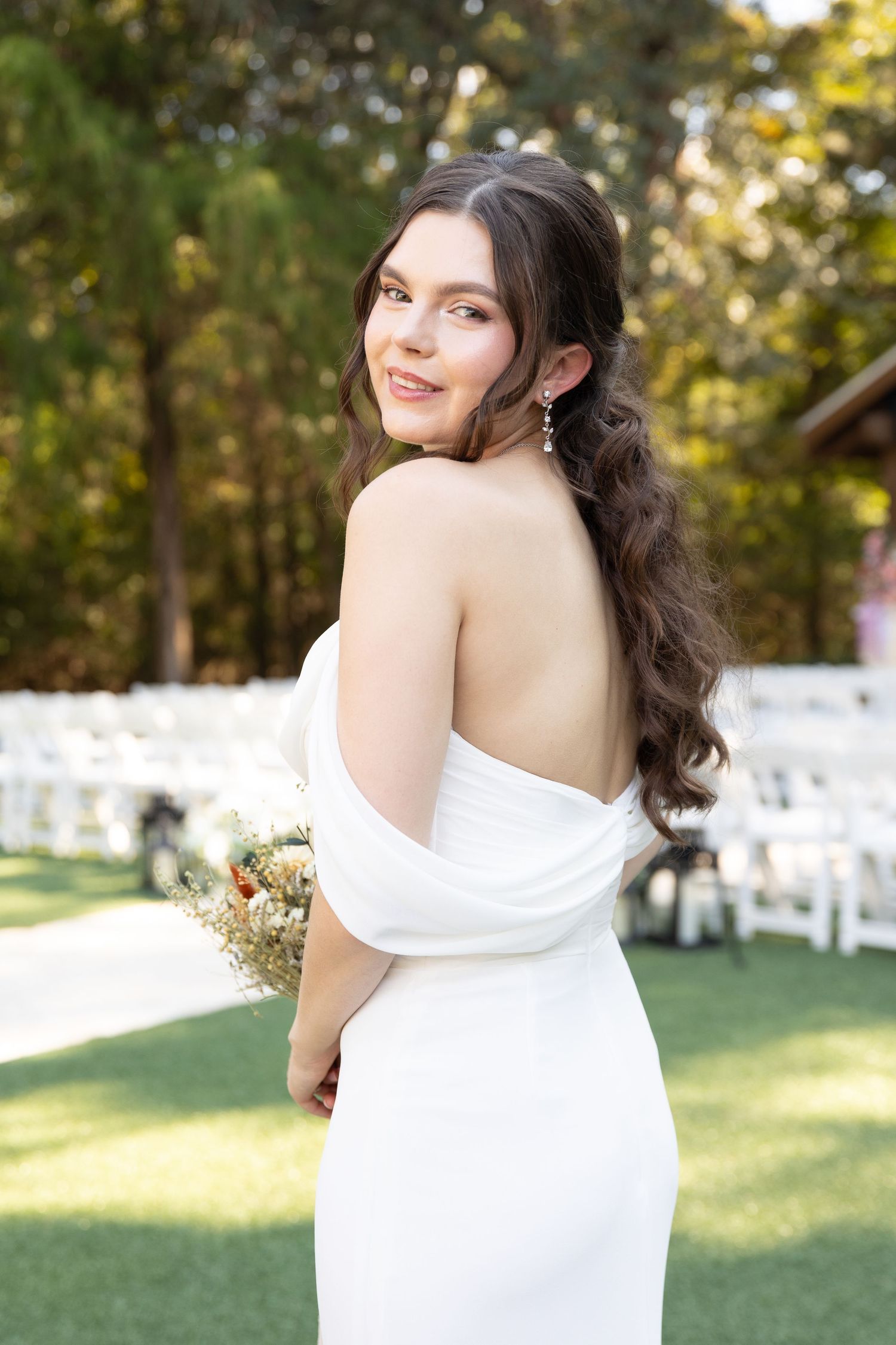 Elegant bridal portraits showcasing a white off-shoulder wedding dress in an outdoor garden setting.