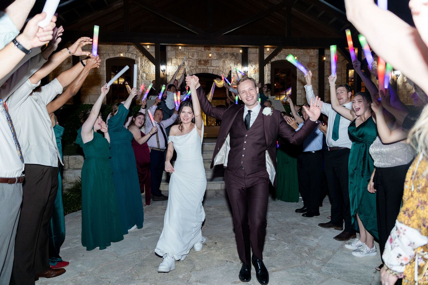 Wedding guests form a celebratory tunnel exit for the newlyweds.