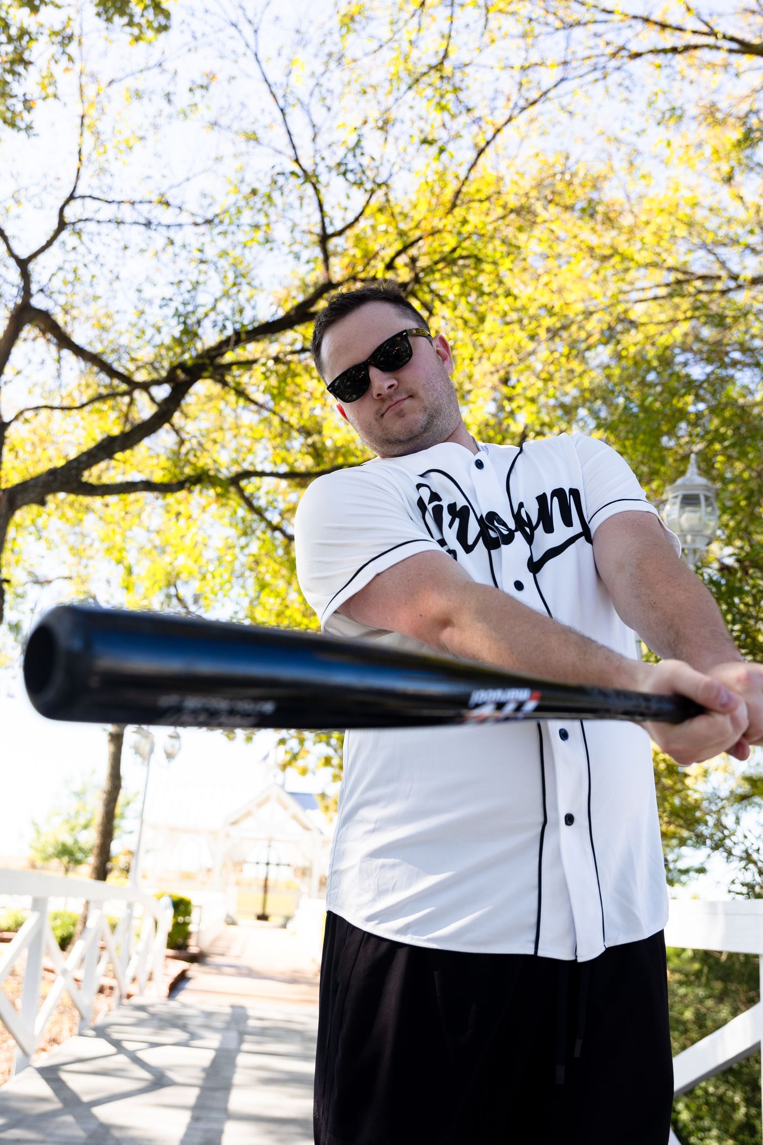 Person in baseball uniform holding a bat in multiple action poses.