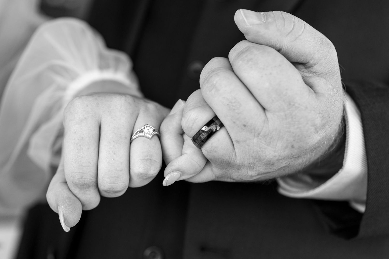 Close-up series of hands and wedding rings in black and white photography.