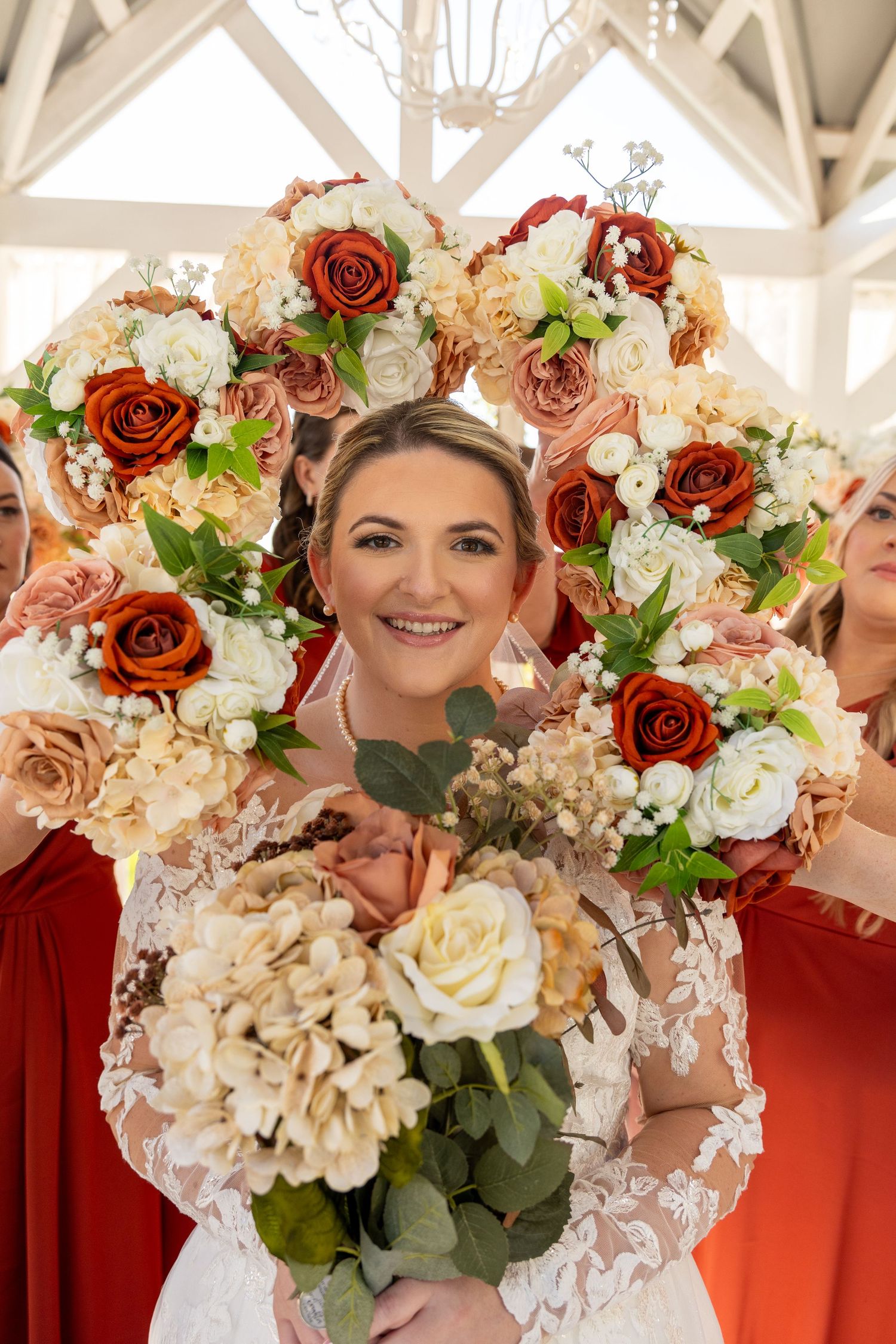 Beautiful bridal bouquet featuring red roses, white flowers, and greenery.