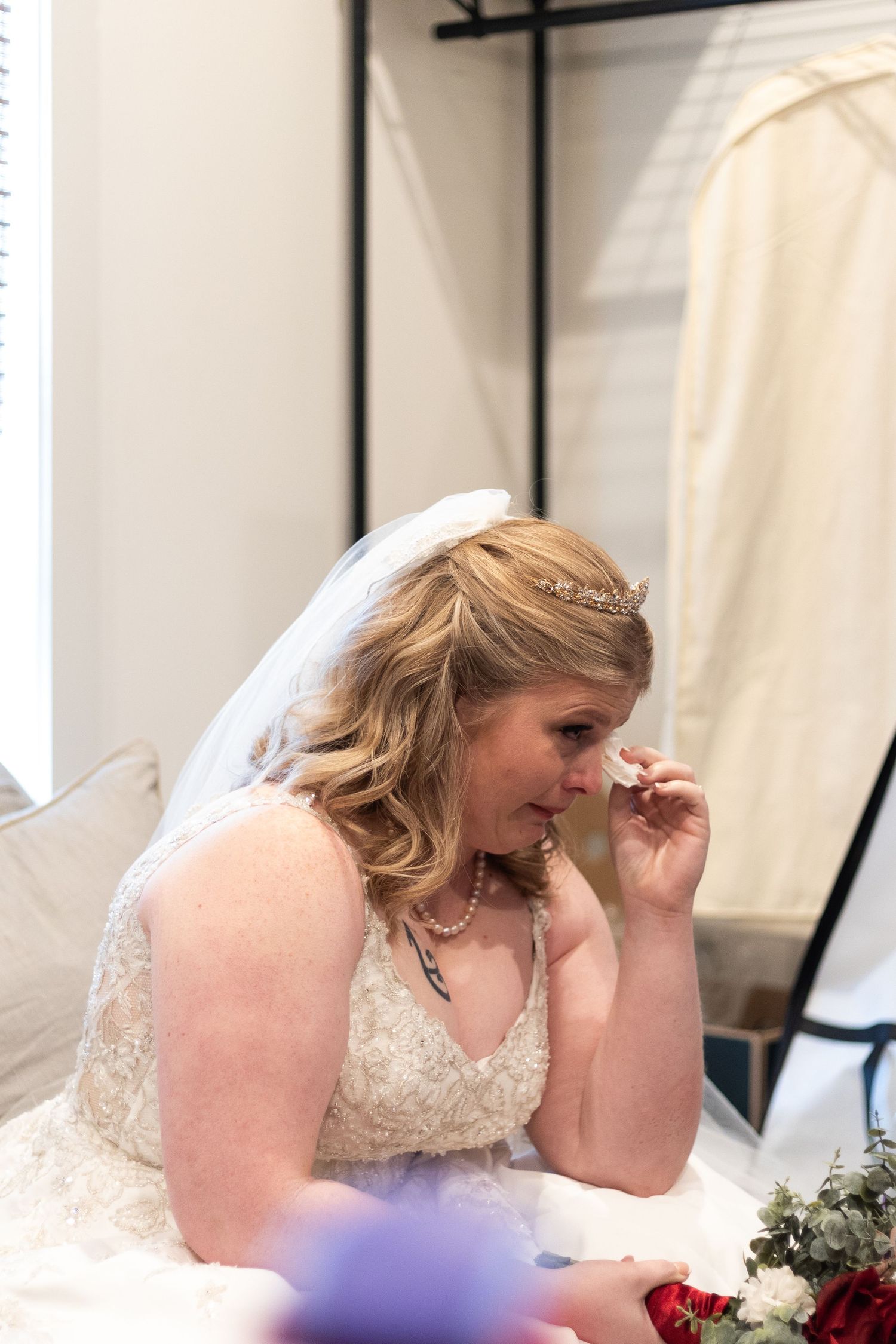 Emotional wedding reception moment captured in soft indoor lighting.