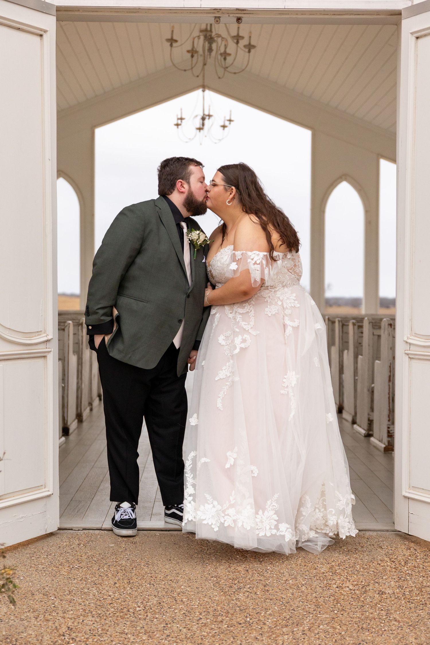 A romantic wedding photoshoot in a white columned venue with elegant decor.