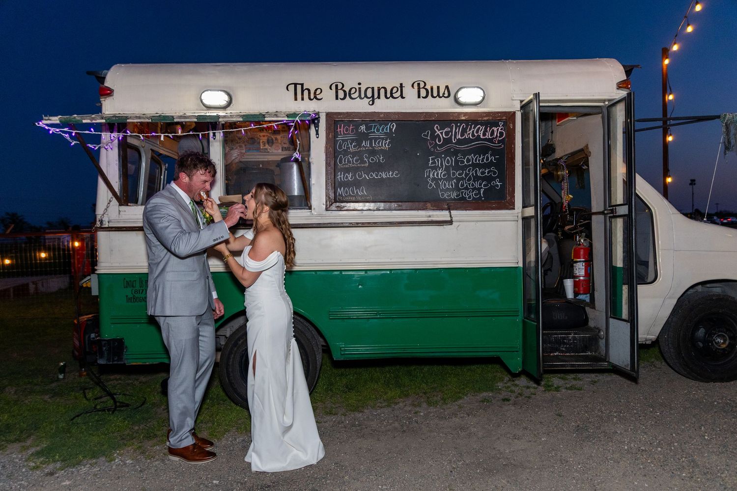 Evening wedding reception scene with food truck and string lights creating ambiance.