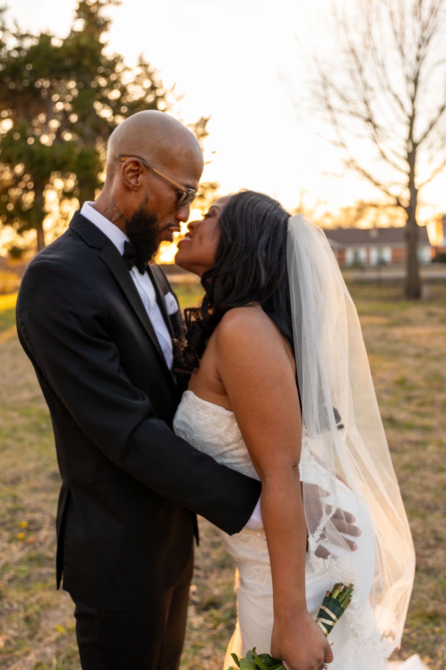 Romantic sunset wedding portraits captured in golden hour light.
