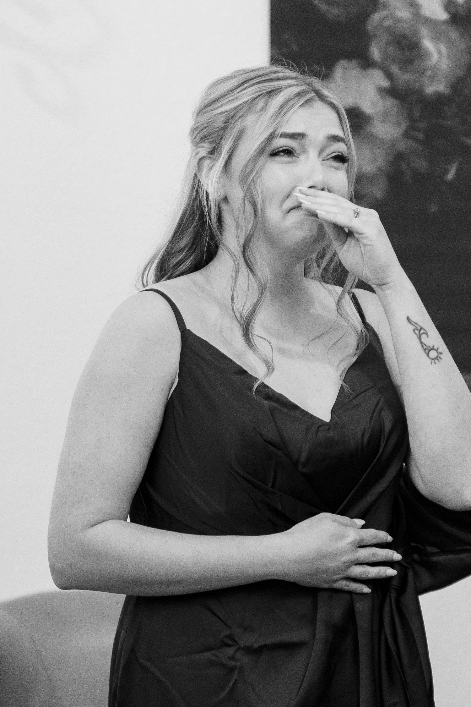 Black and white candid photos showing joyful laughter in formal attire.