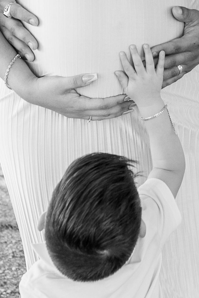 Close-up shots of hands gently touching a baby's head.