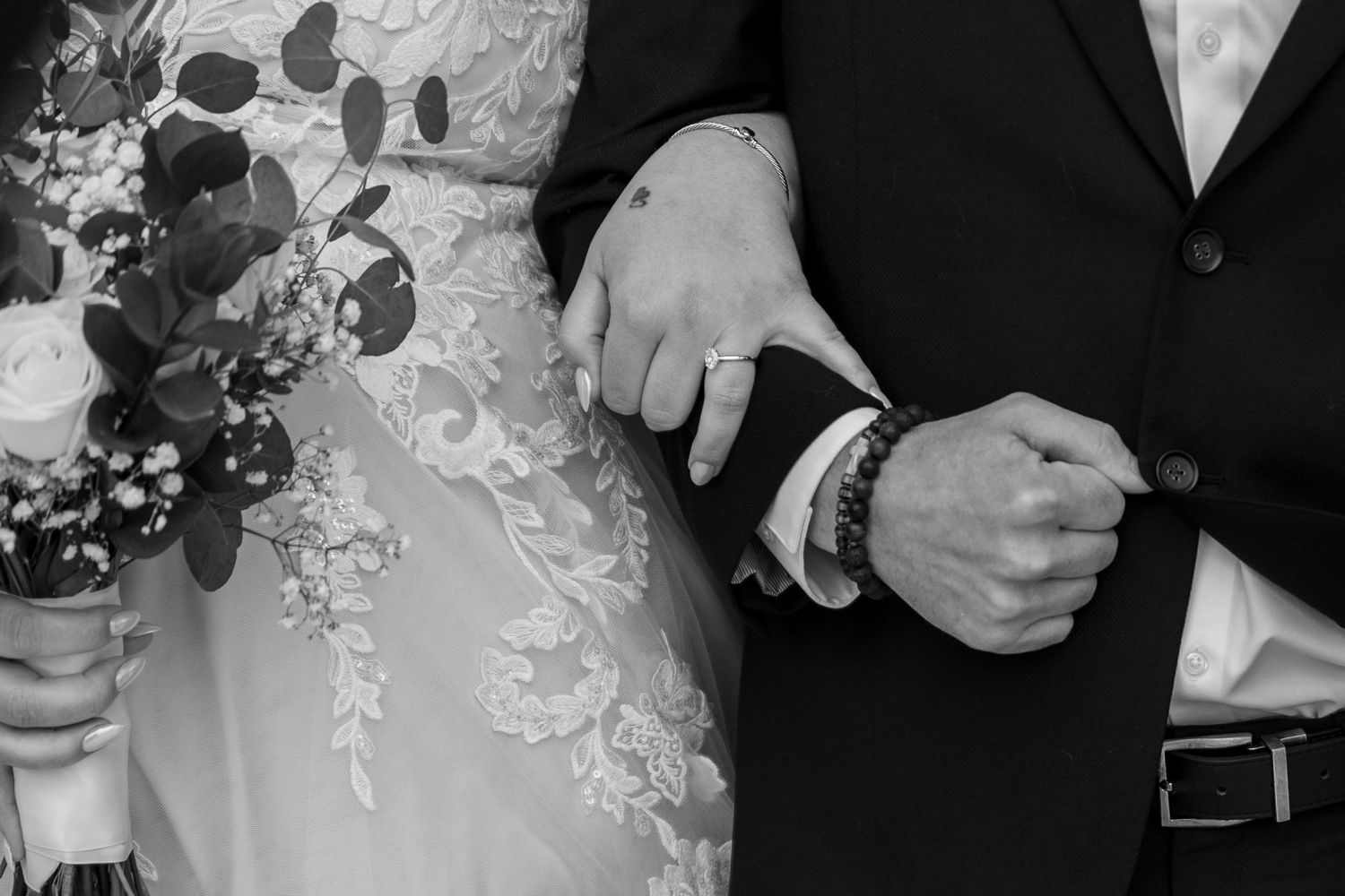 Close-up of wedding dress details showing intricate lace patterns.