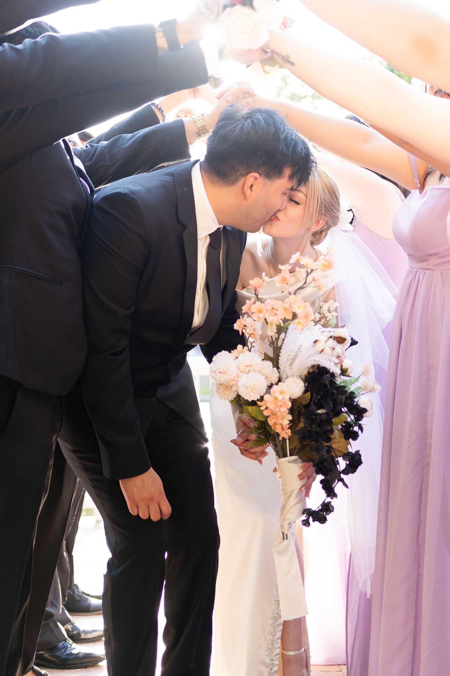 A series of wedding ceremony kisses between the bride and groom in formal attire.