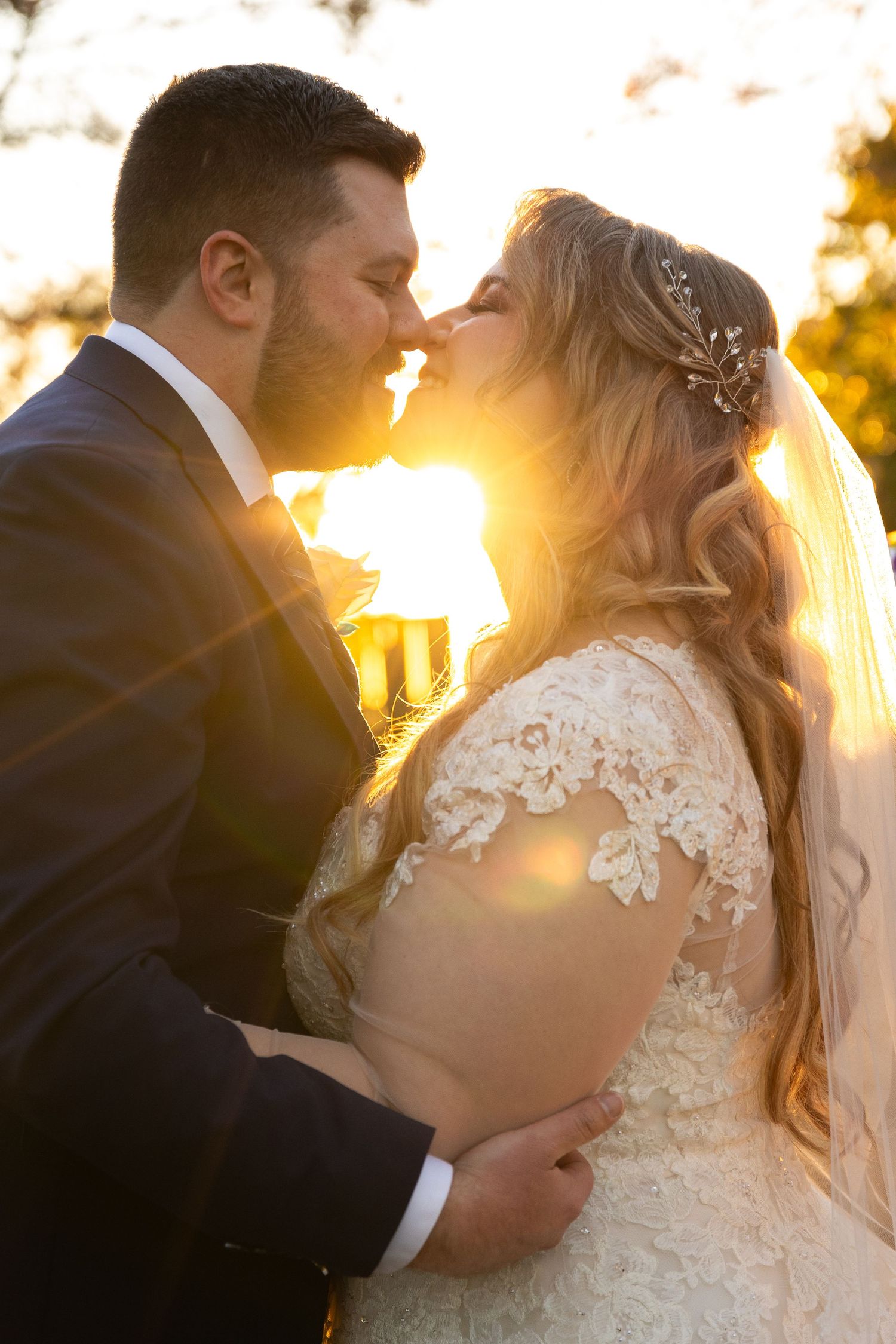 Sunset wedding portraits with golden backlighting through lace details.