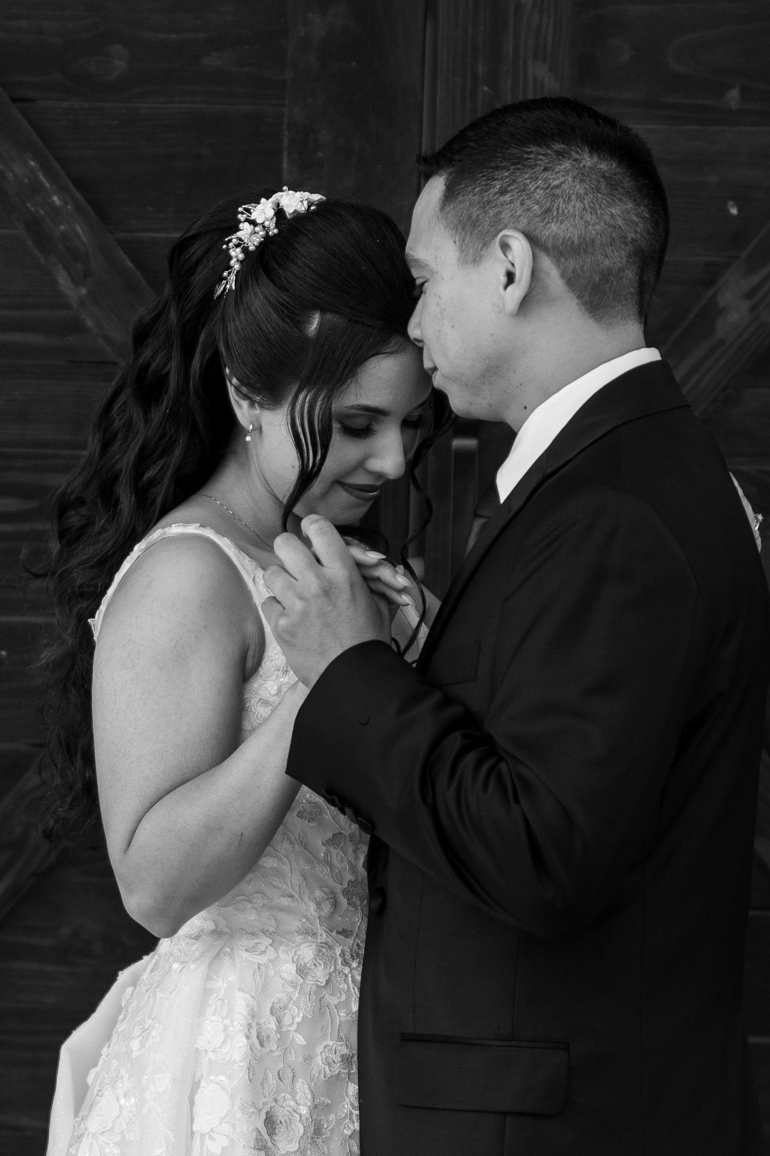 Intimate black and white portraits capture tender moments between newlyweds.