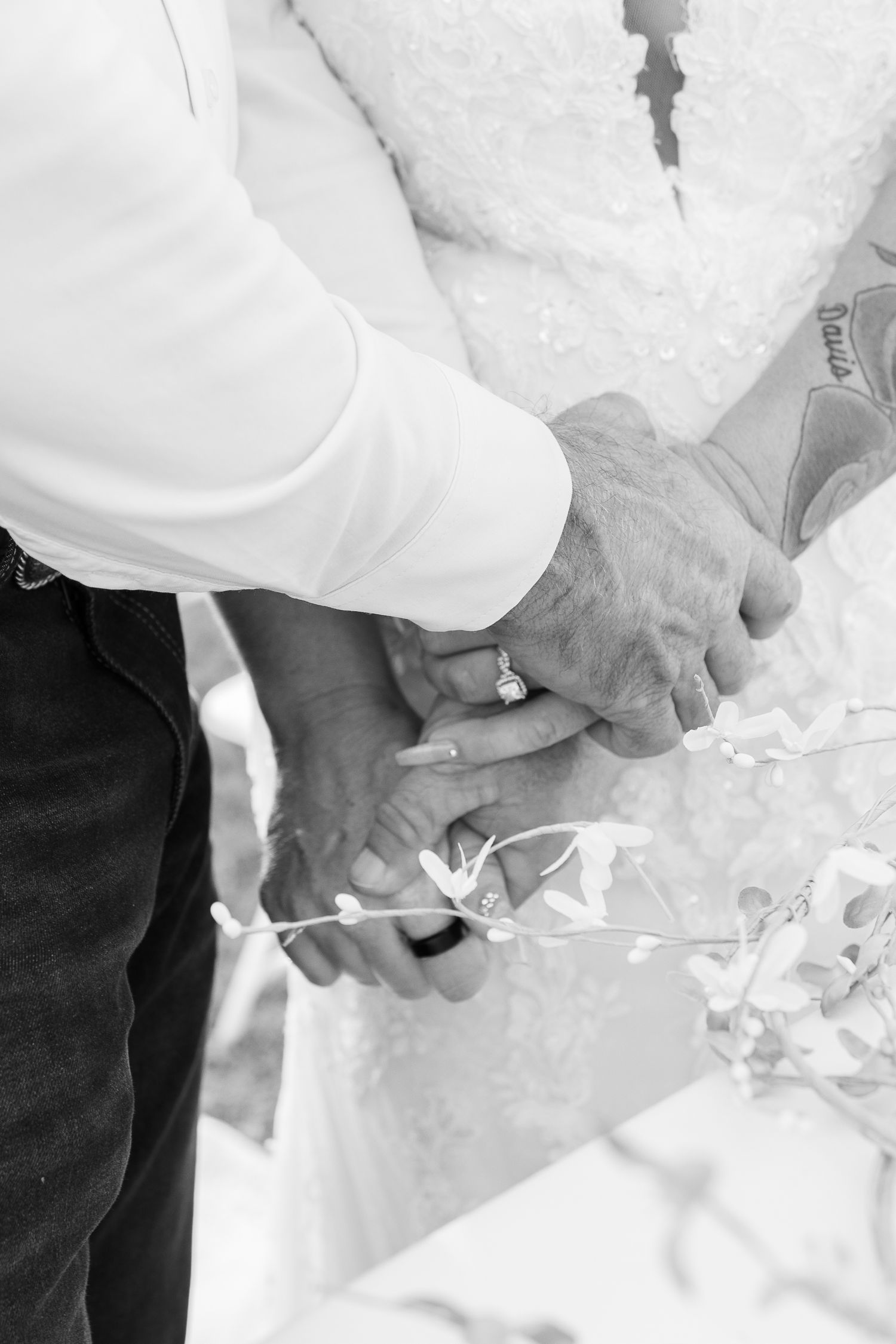 Close-up black and white detail shots of hands during a wedding ceremony.