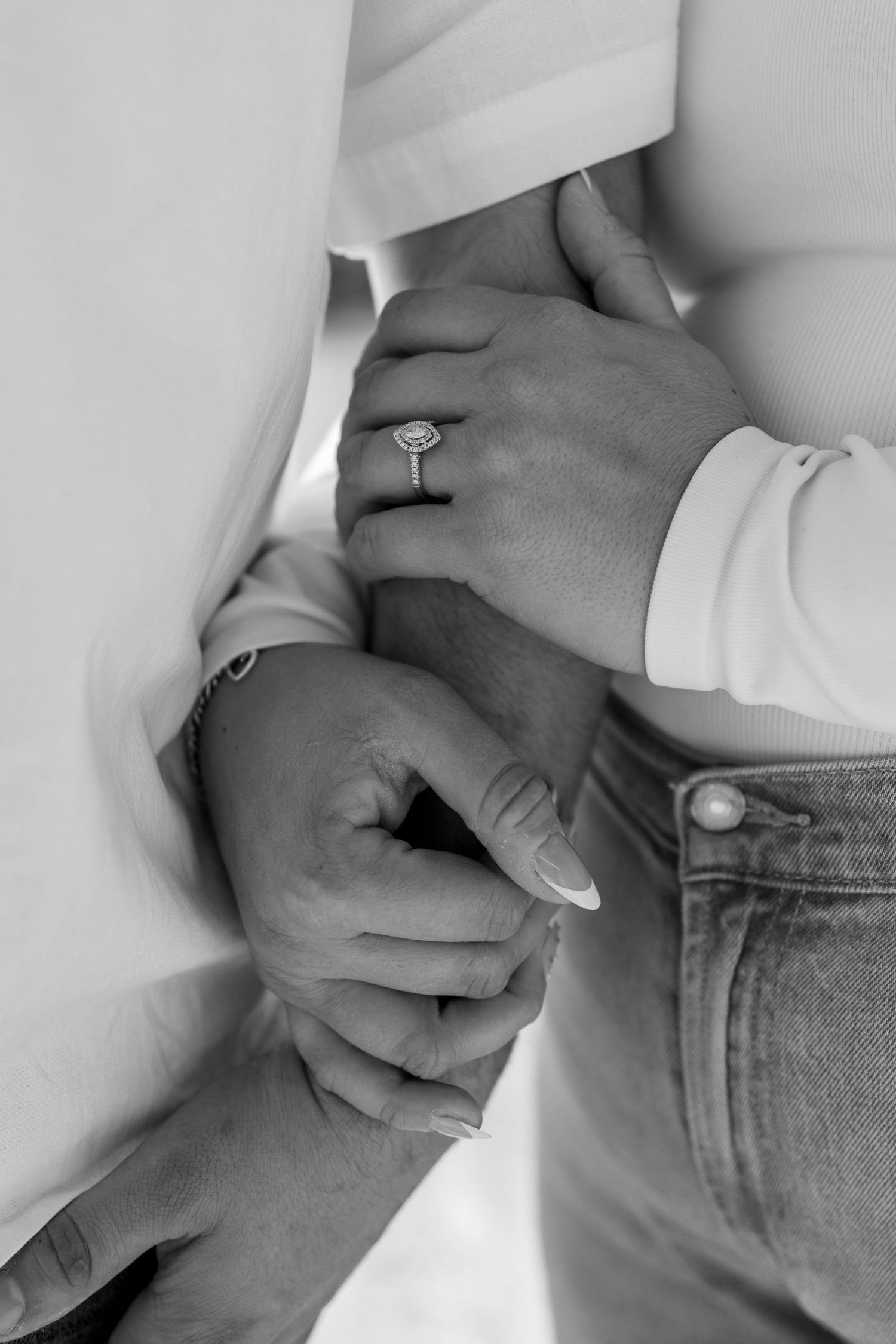Close-up series of hands holding each other tenderly showing engagement ring and emotional connection.