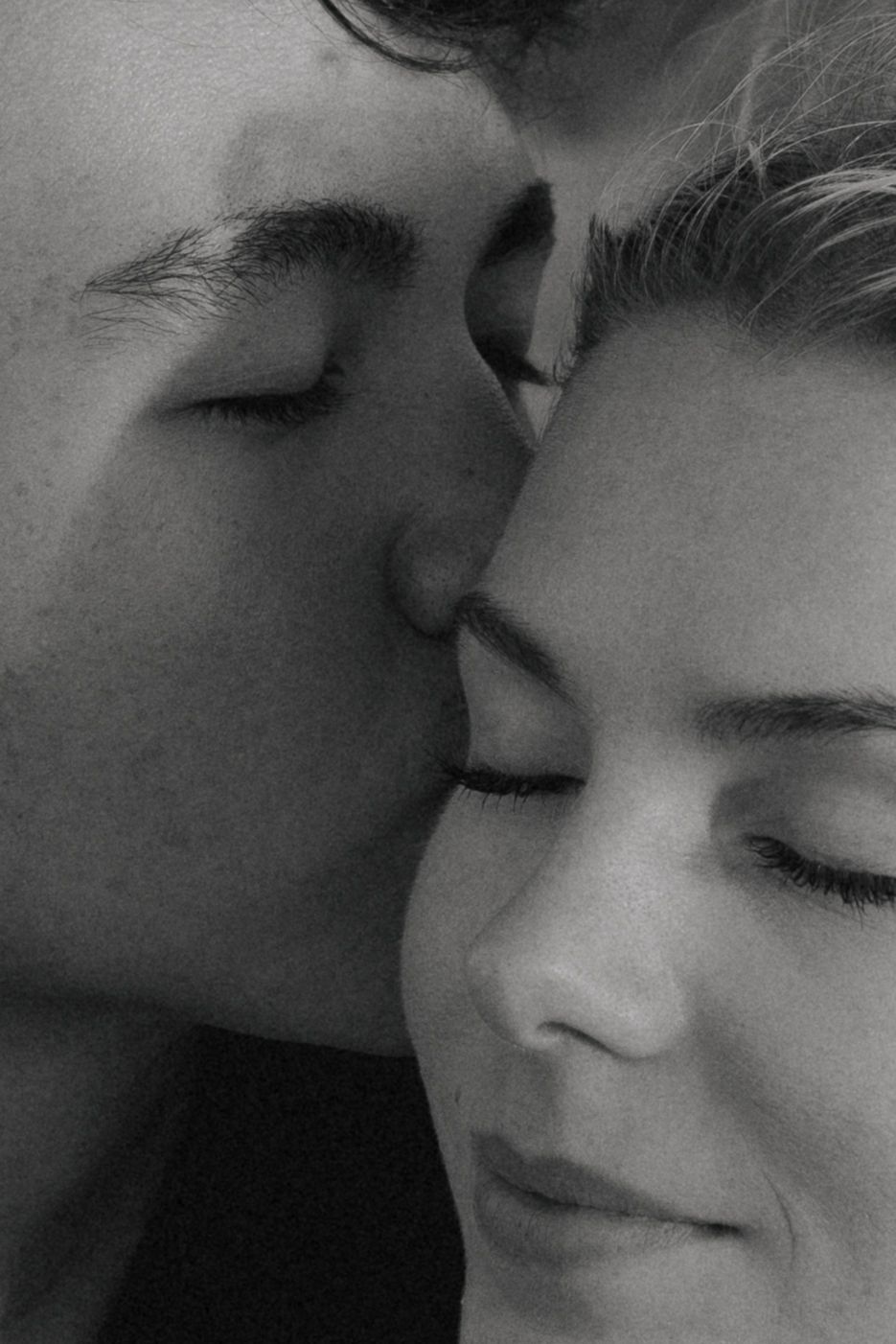 Black and white close-up of an intimate moment between two people.