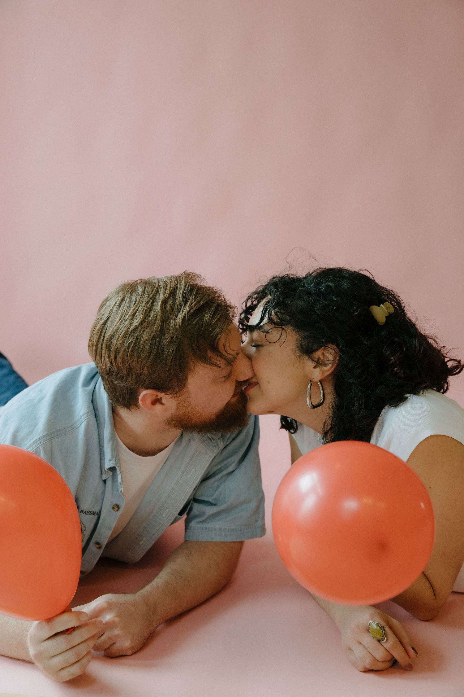 couples photoshoot with couple kissing in studio in richmond virginia for a valentines day photoshoot