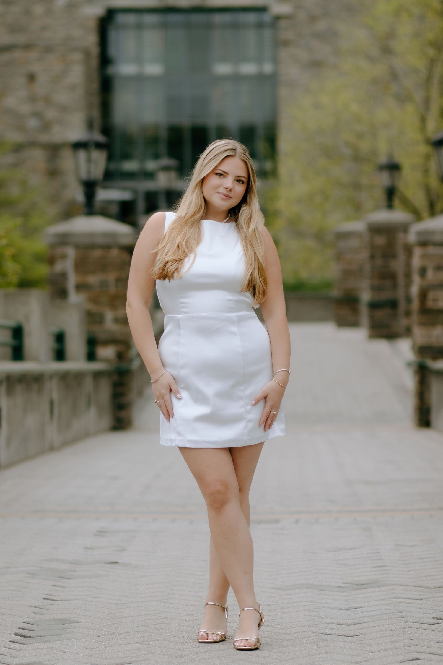 Casual poses captured on a stone pathway in front of an institutional building.