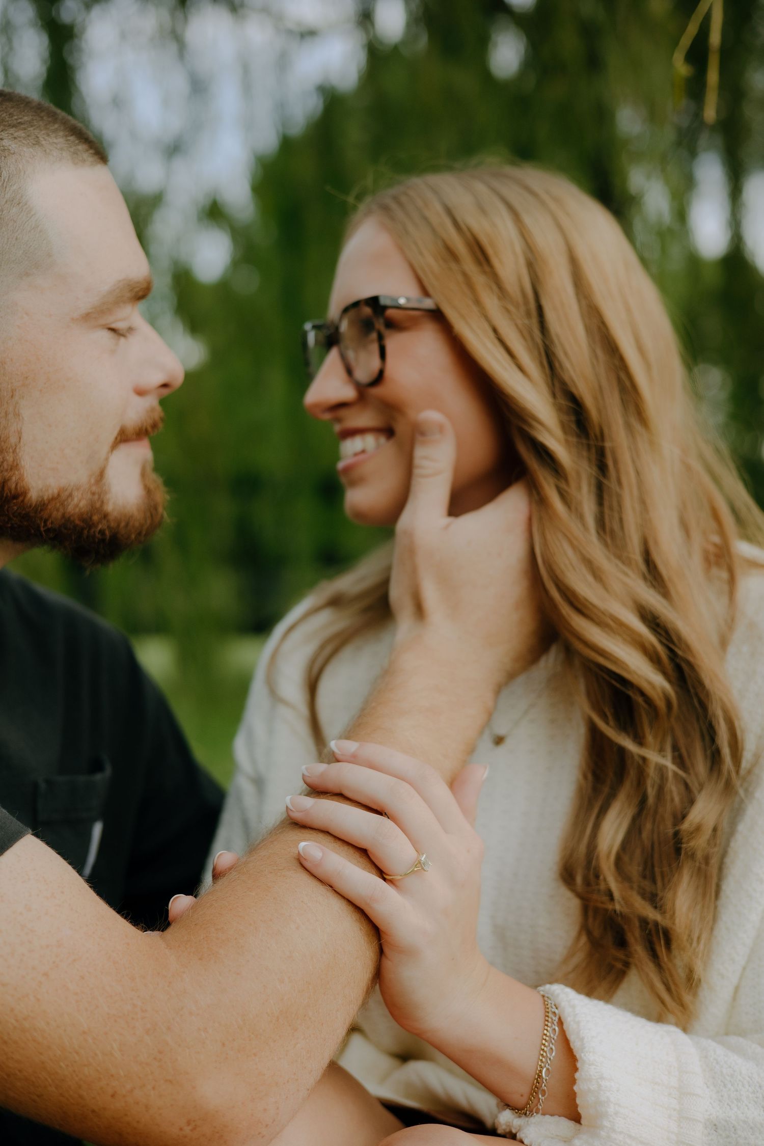 Intimate close-up portrait of couple sharing a tender moment outdoors.