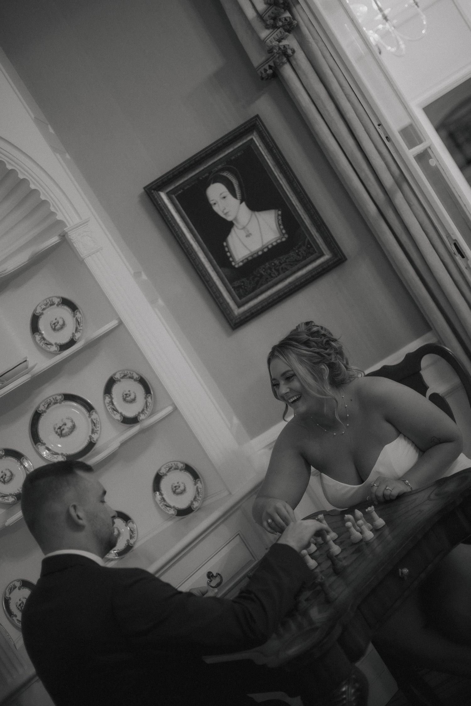 A series of black and white photographs showing a couple in an intimate moment together on a couch in a living room setting.