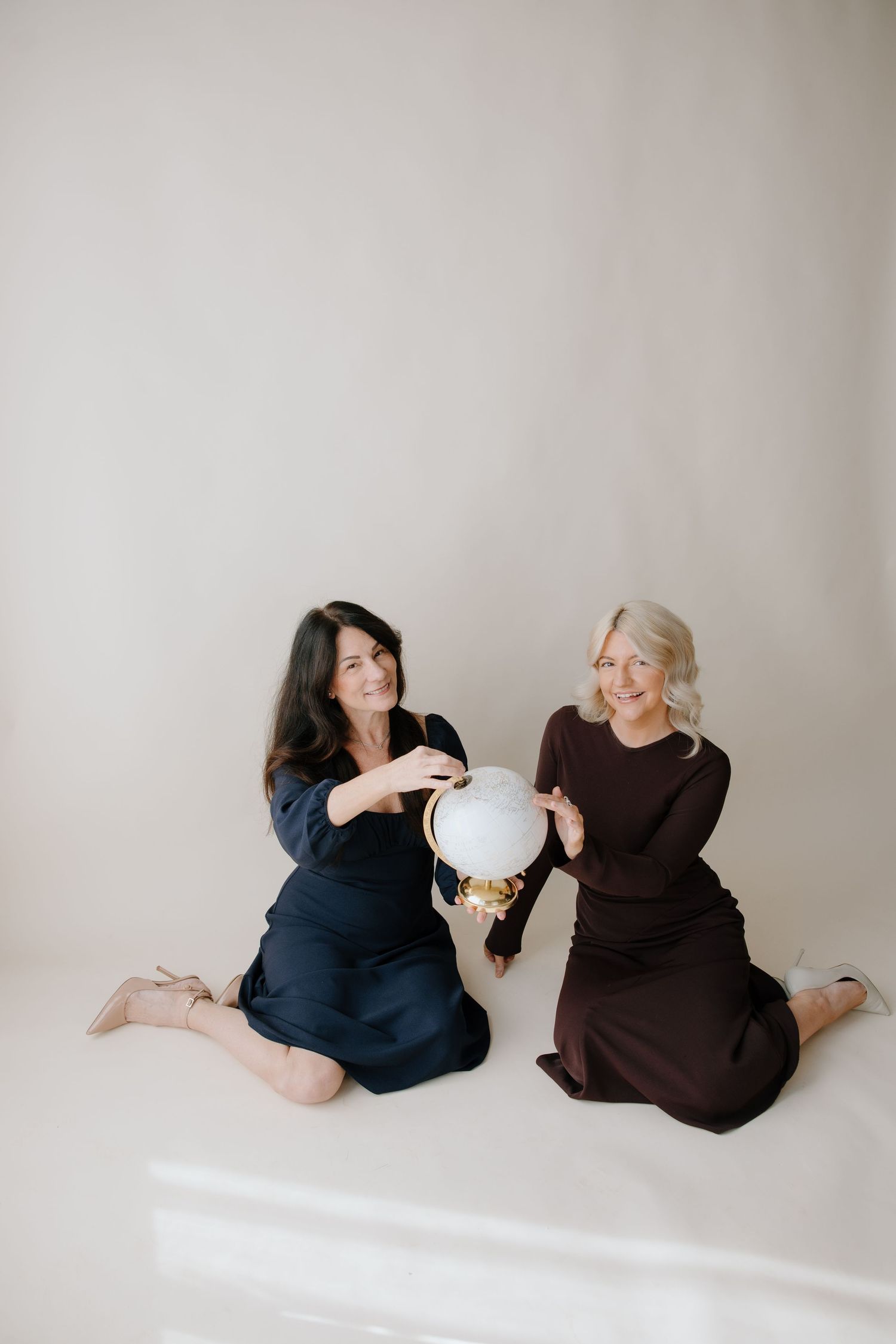 branding photos with globe prop at the studio on broad in richmond, va shot by virginia branding photographer