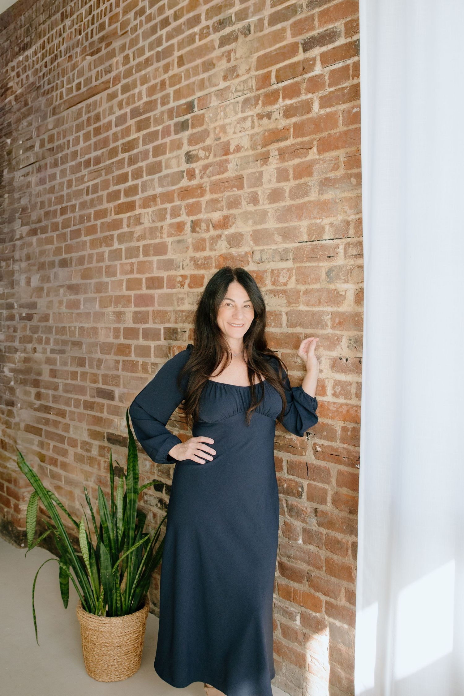 branding headshots in front of brick wall at the studio on broad shot by virginia branding photographer