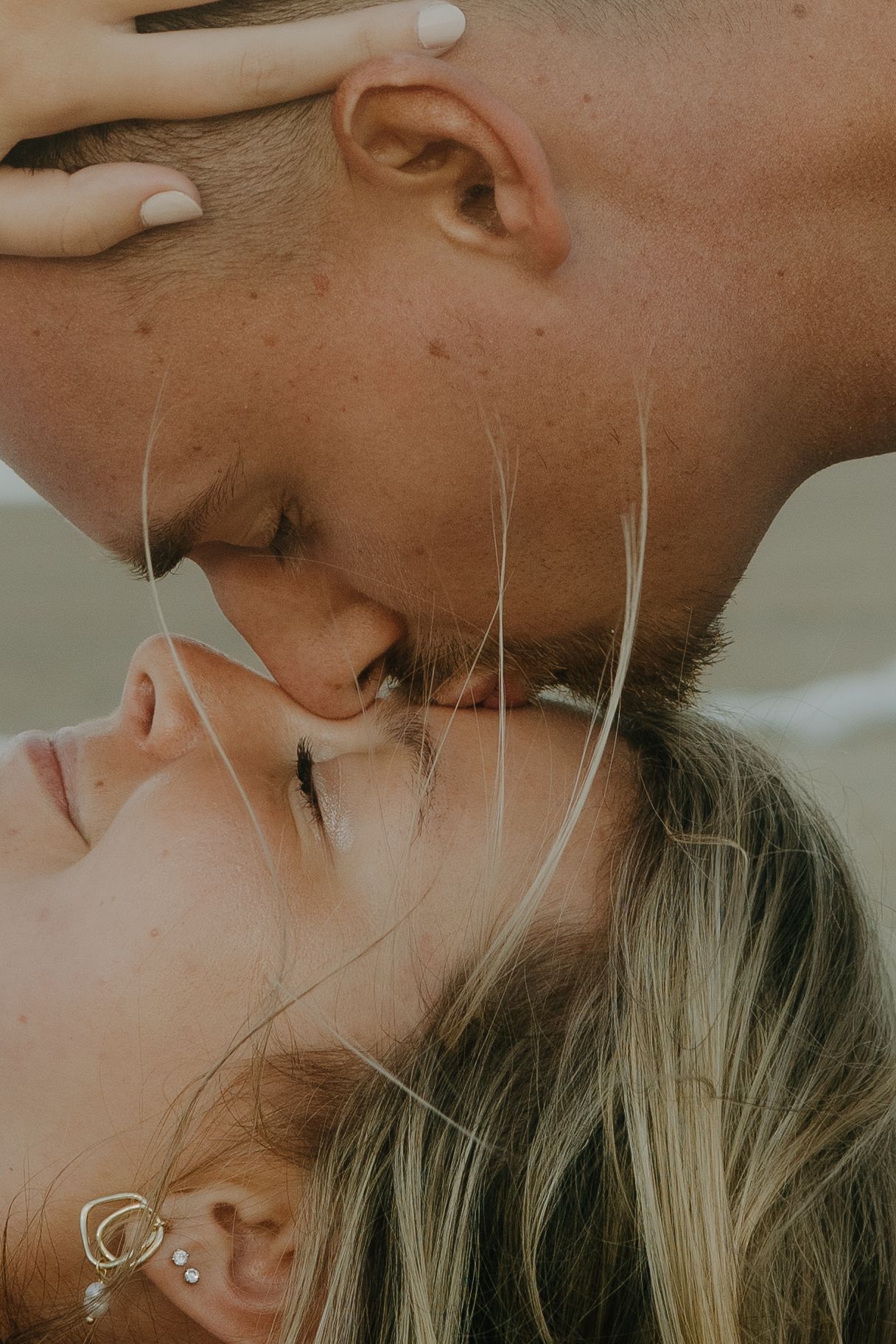 A romantic close-up sequence showing tender moments between a couple in soft lighting.
