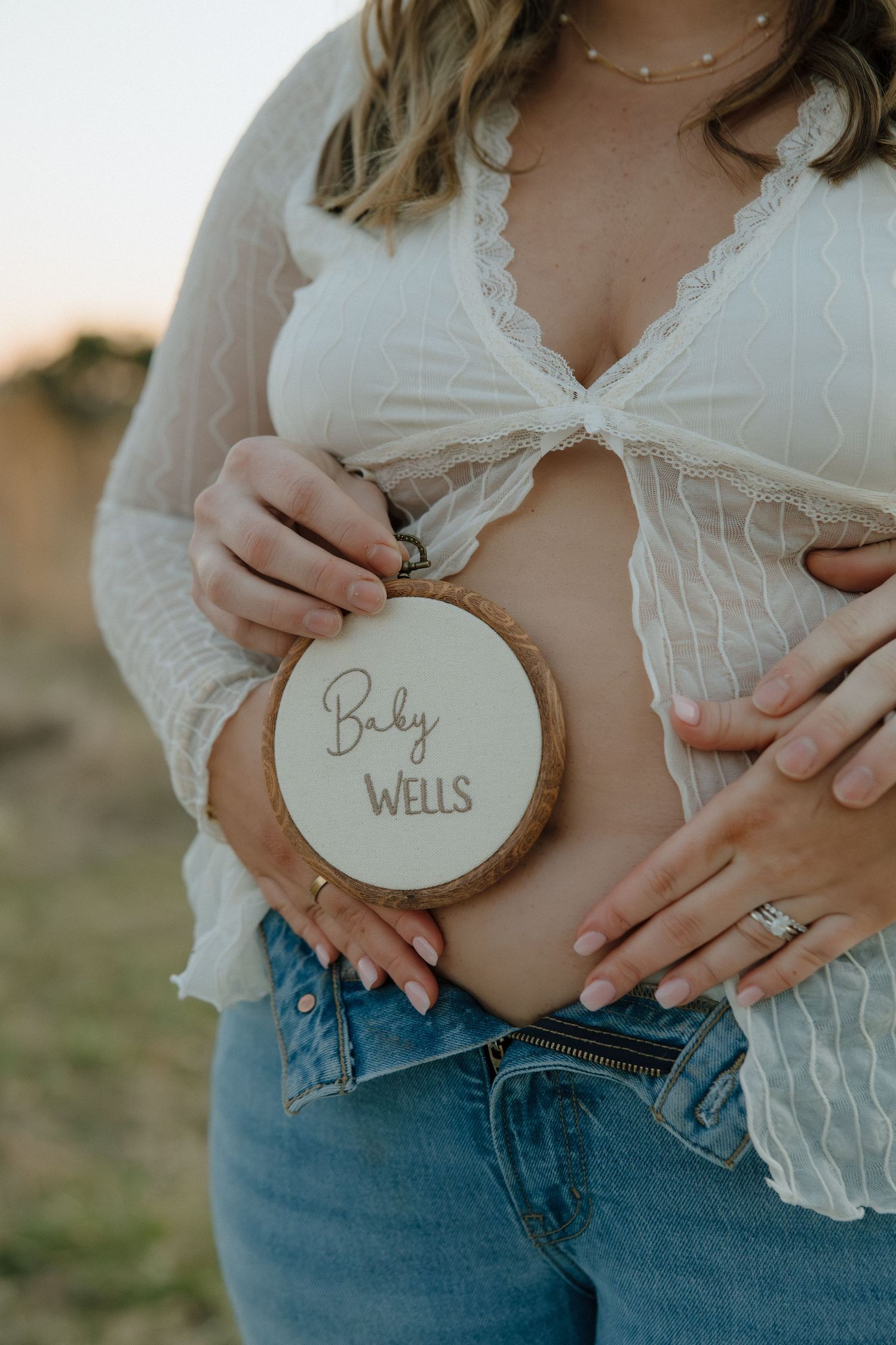 Pregnancy Announcement photoshoot prop idea, embroidered baby name shot by virginia maternity photographer