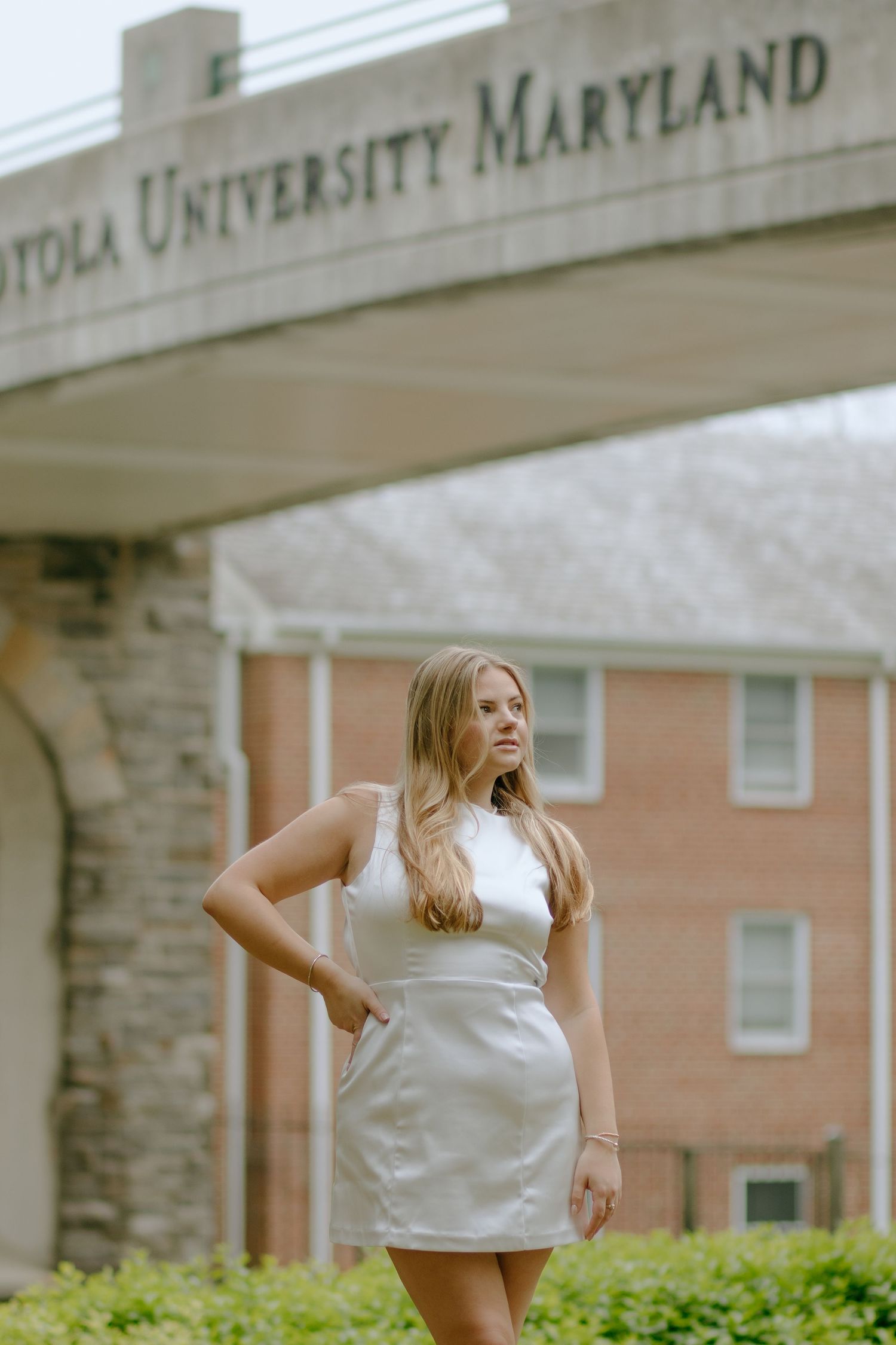 Outdoor photoshoot at University of Maryland campus with stone architecture visible.