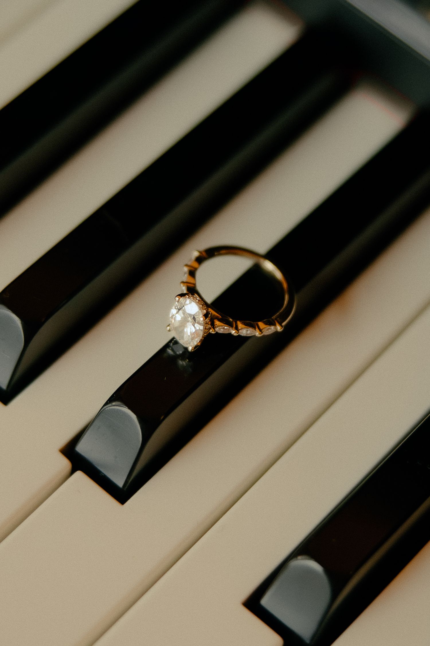 detail shot of engagement ring on piano from engagement photoshoot at The Inn at Warner Hall in Gloucester, VA shot by virginia photographer