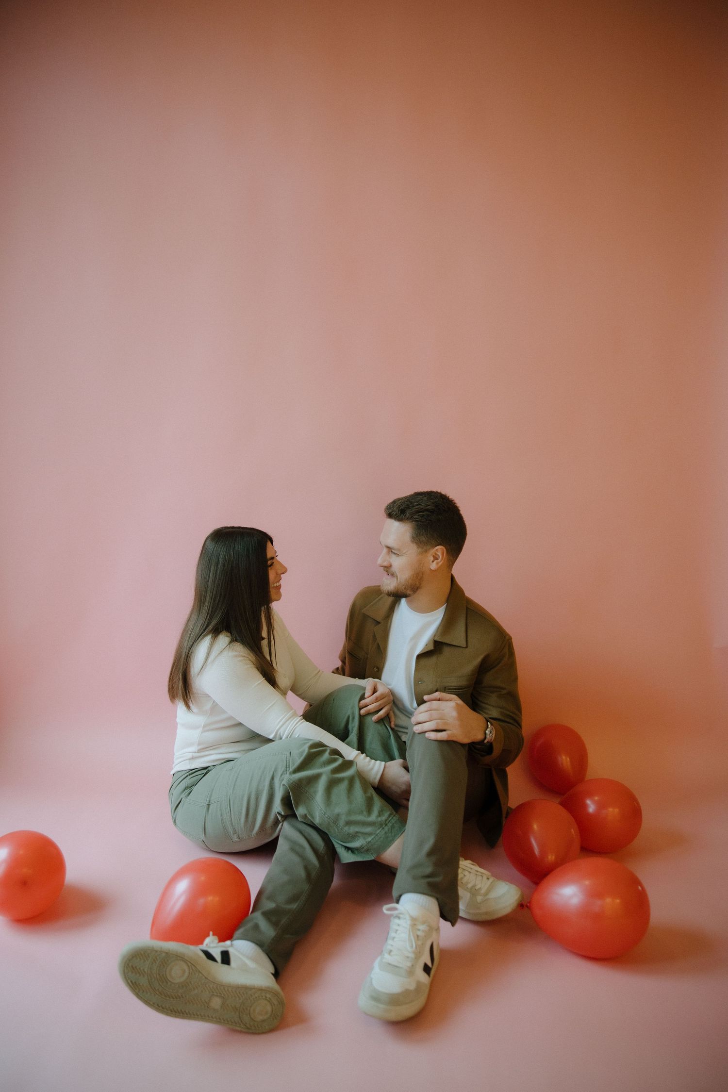 Couple in casual outfits in a studio in richmond virginia for a valentines day photoshoot captured by a virginia couples photographer