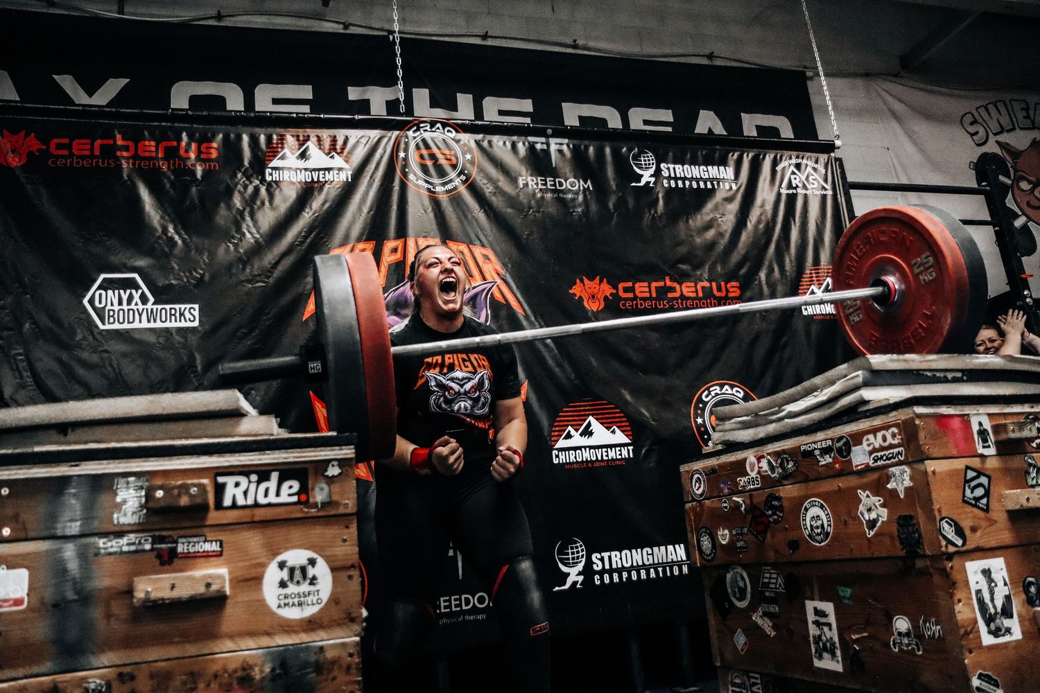 Strongman athlete competing in the behind the neck press at The Sweaty Pig gym in Murray Utah