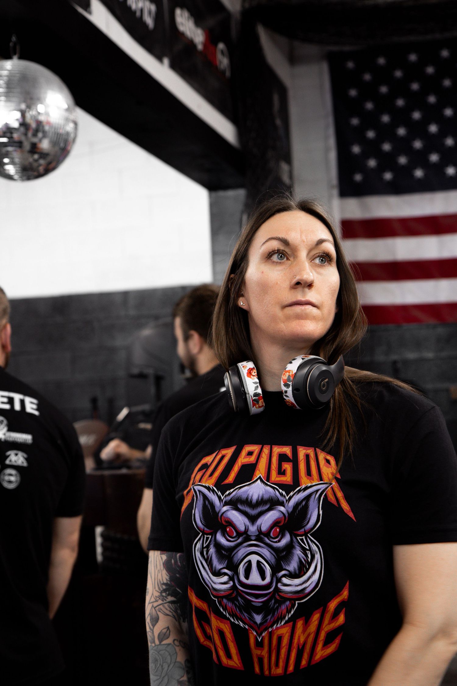 Athletic apparel with a fierce boar logo design displayed in a gym setting with American flag.