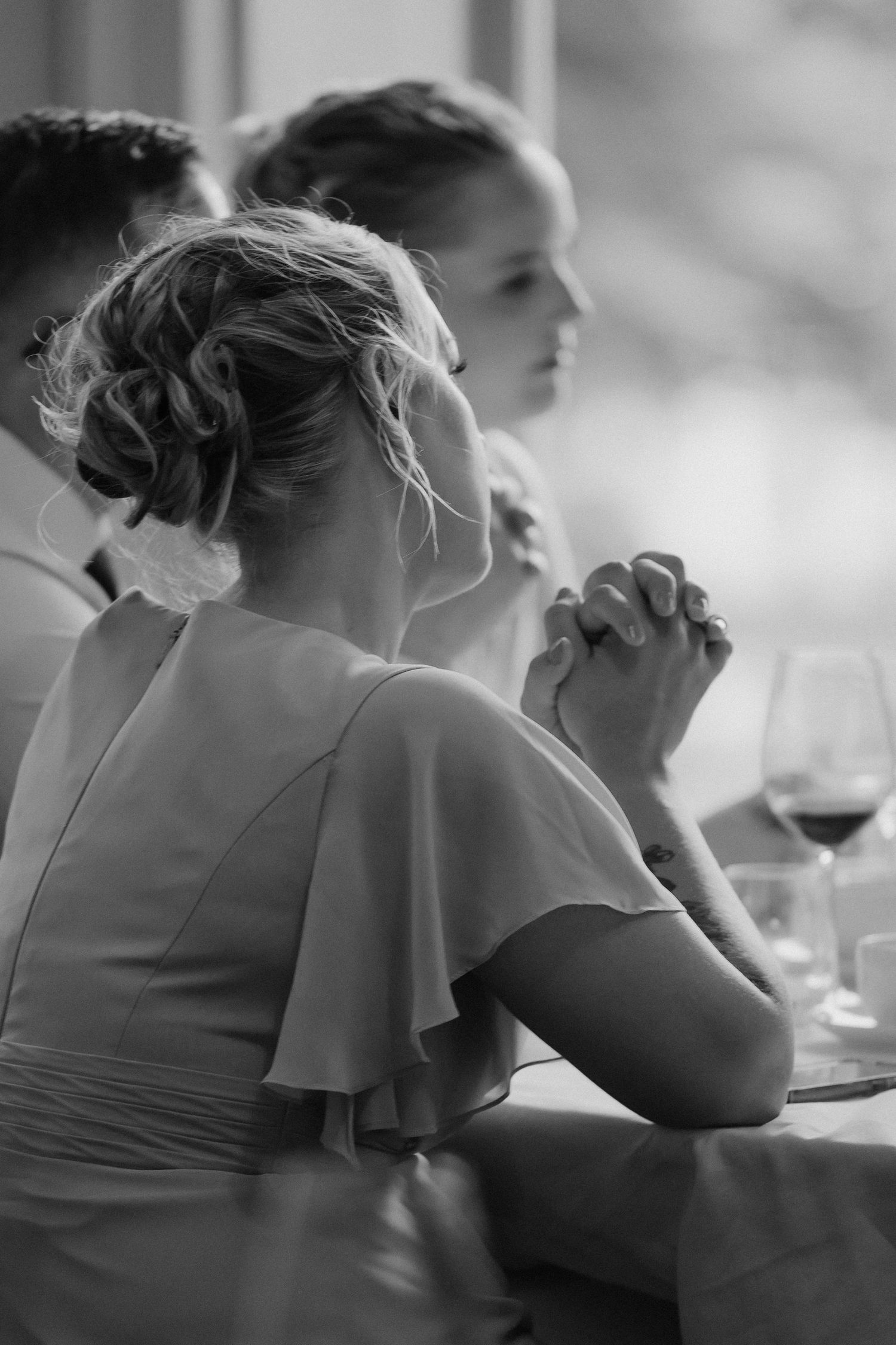 A series of black and white photographs showing intimate moments during a wedding reception.