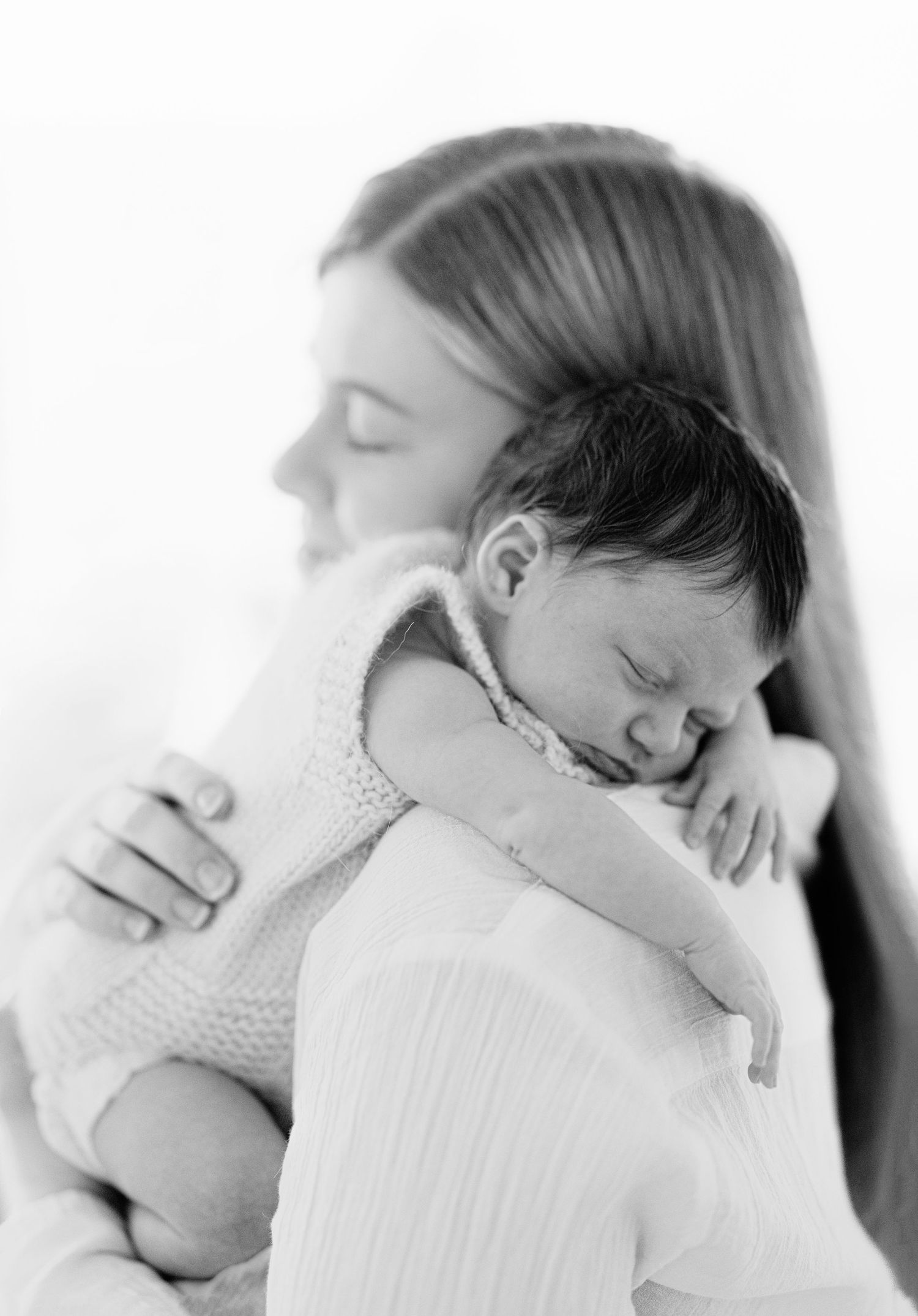 A series of black and white close-up photos showing a tender embrace between two people in intimate poses.