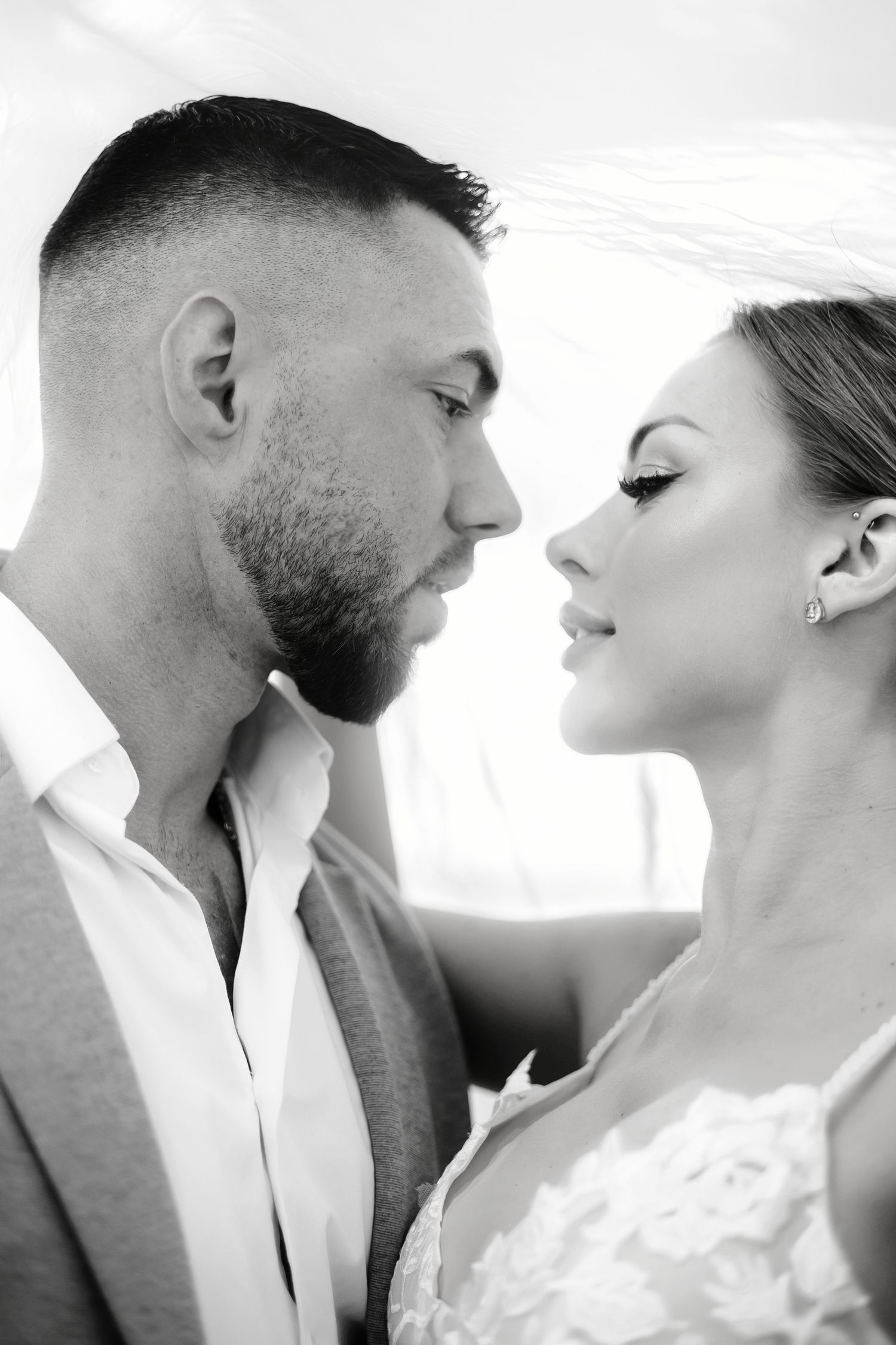 A romantic black and white photo series showing an intimate moment between a couple in formal attire.
