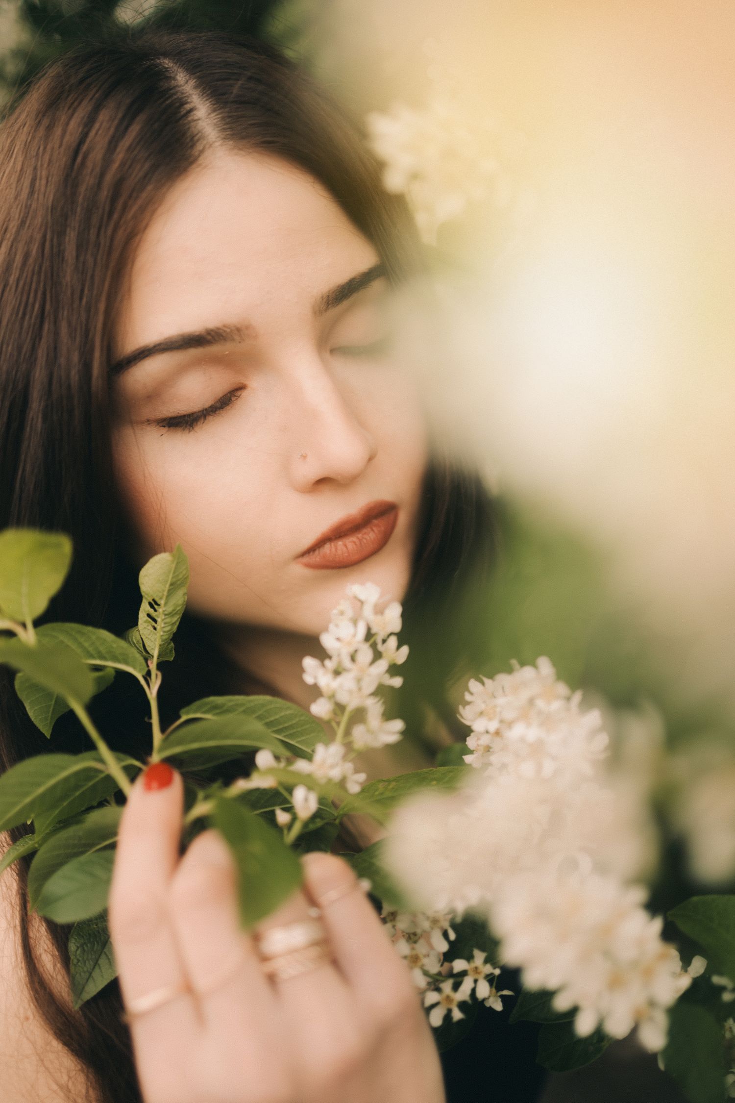 Soft ethereal portrait series showing delicate white spring blossoms against a dreamy bokeh background.