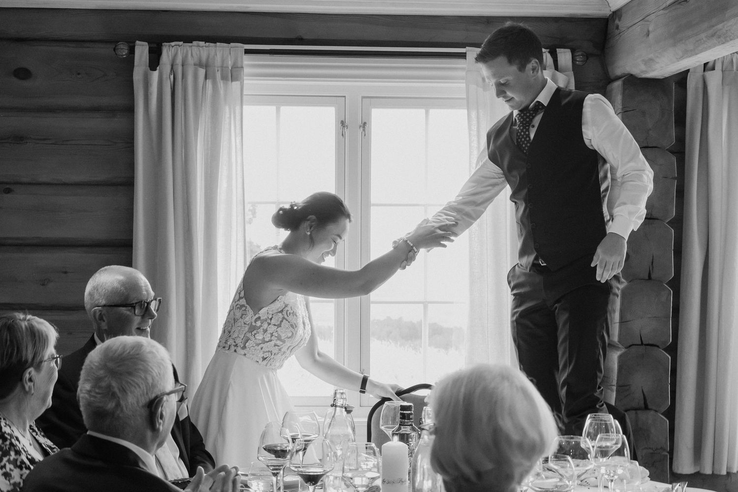 Black and white photo montage showing people dining and socializing at a rustic restaurant or lodge setting.