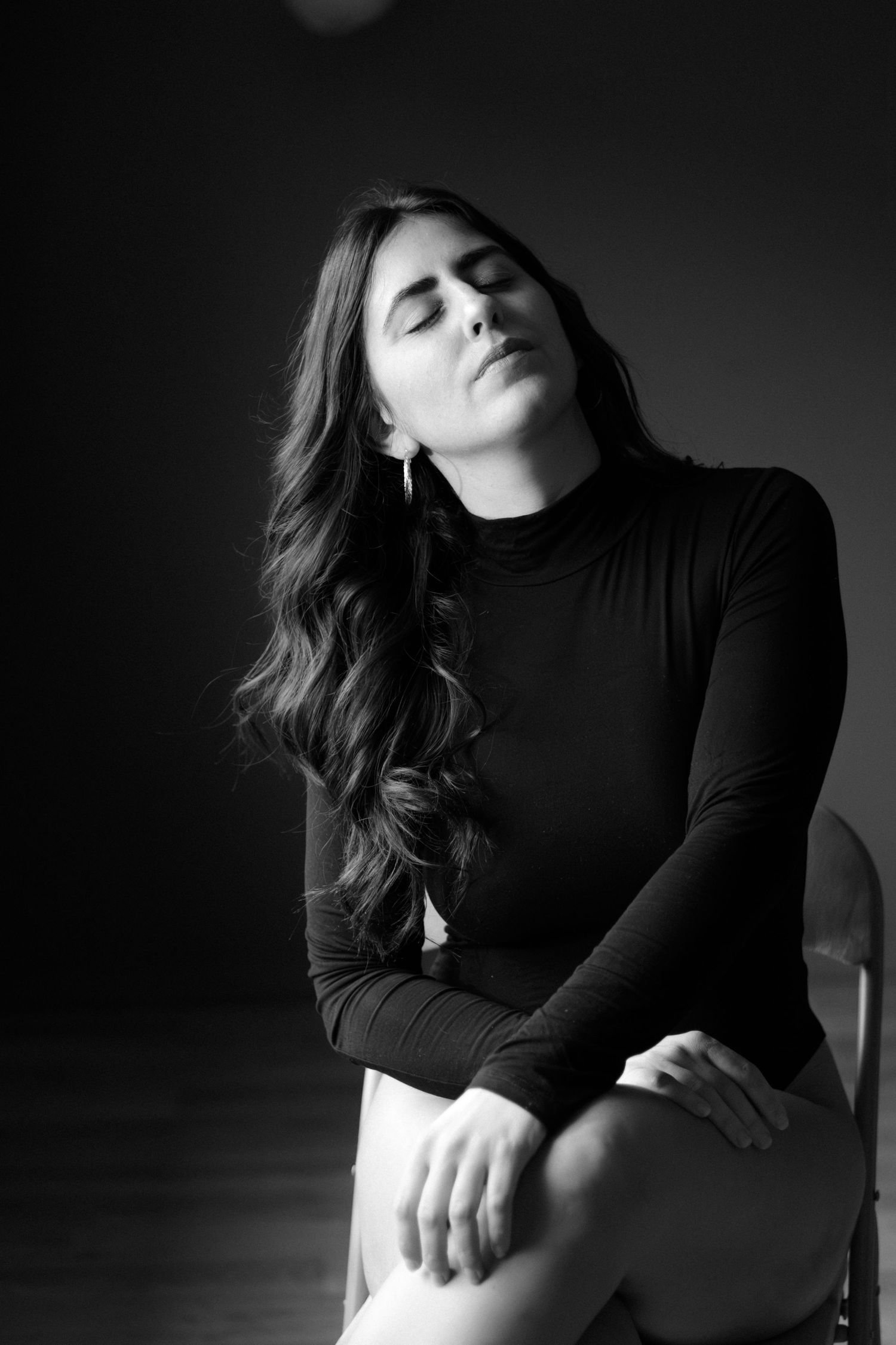 Artistic black and white portrait series in dramatic lighting.