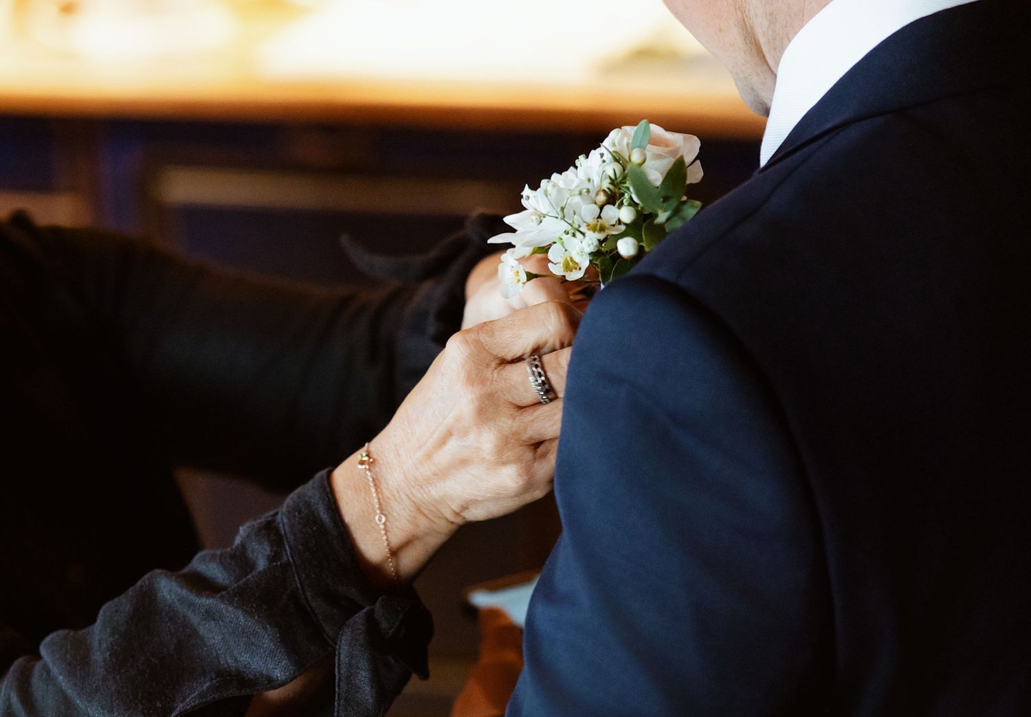 A collection of wedding photos showing hands holding flowers and bouquets in natural light.