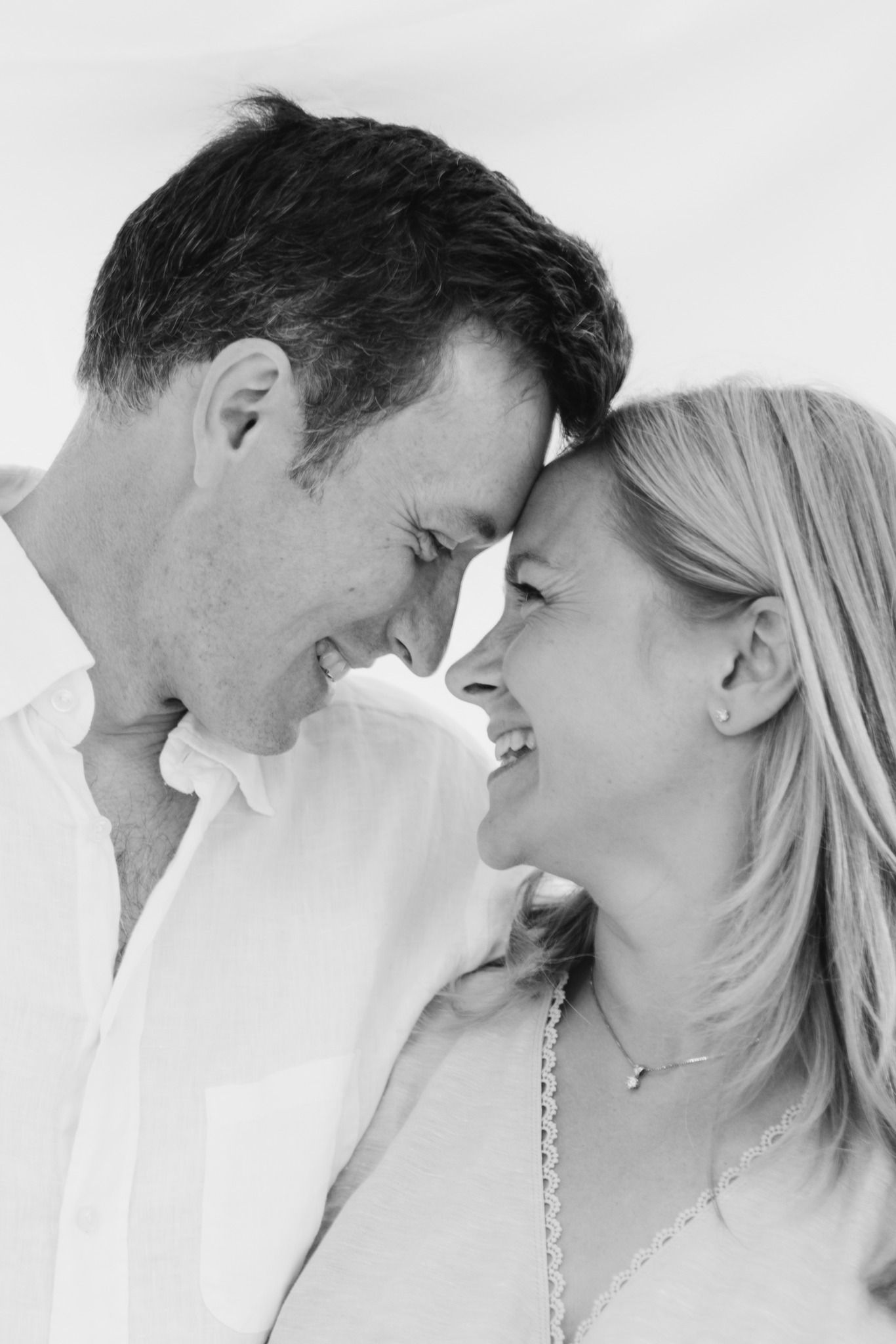 A romantic black and white photo series showing a couple in an intimate close-up moment.
