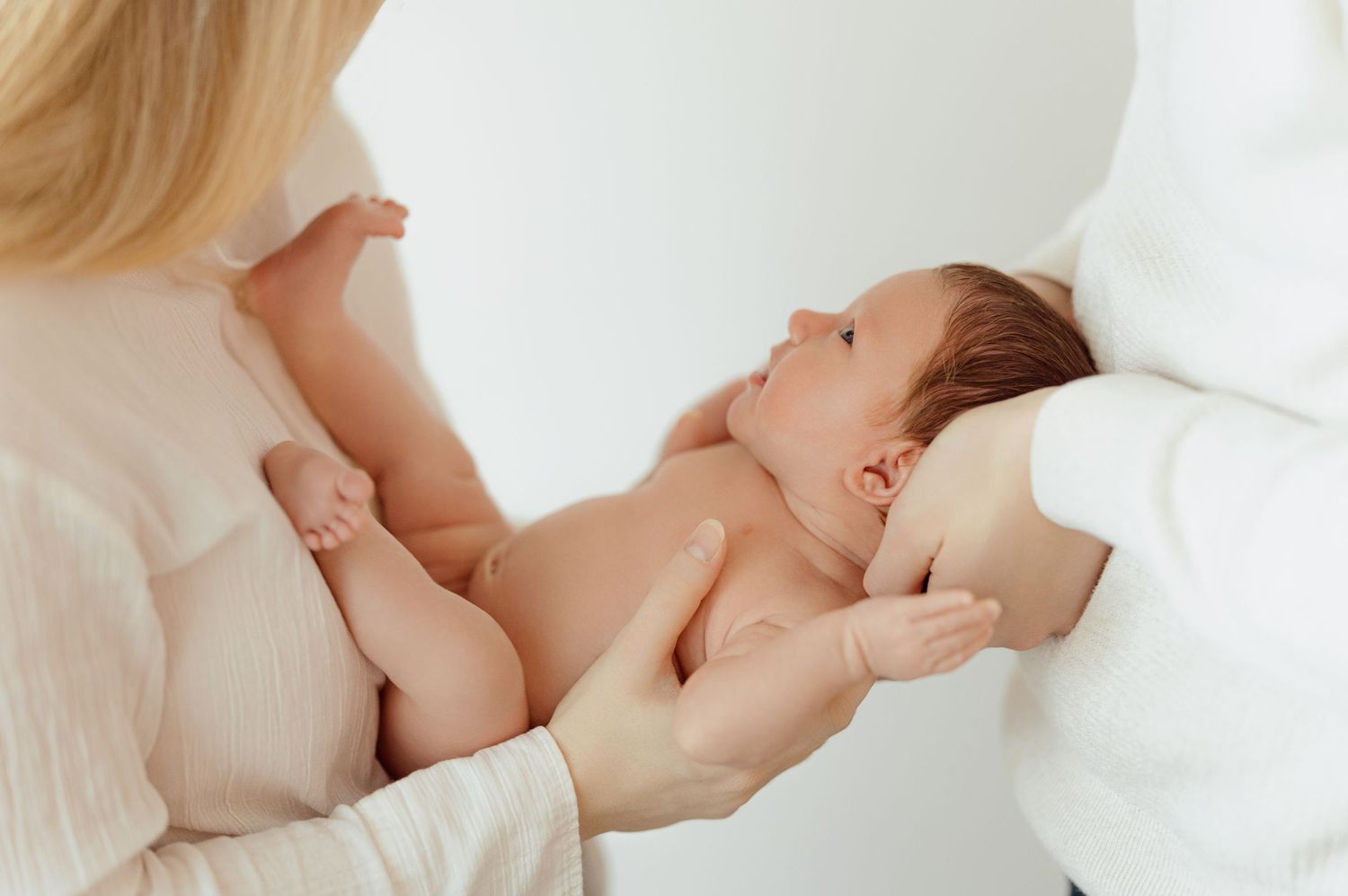 A mother breastfeeding her baby in a series of intimate nurturing moments captured in soft, natural light.